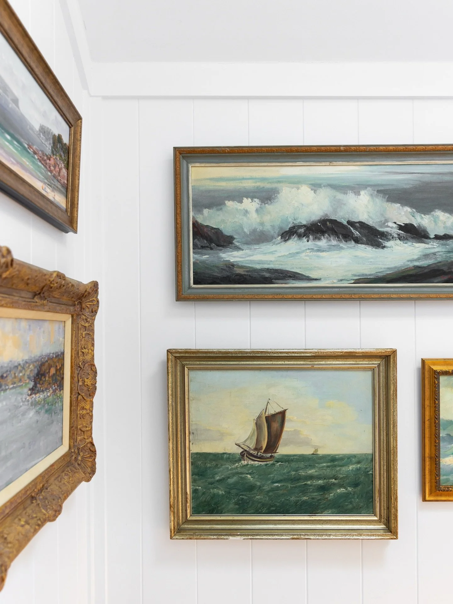 A collection of vintage coastal artworks, curated by our clients, adorn the stairwell walls at our Chinaman&rsquo;s Beach, Mosman project. Project @strittdesignandconstruction. Photography @simonwhitbreadphoto. #chinamansbeachhouse #strittdesignandco