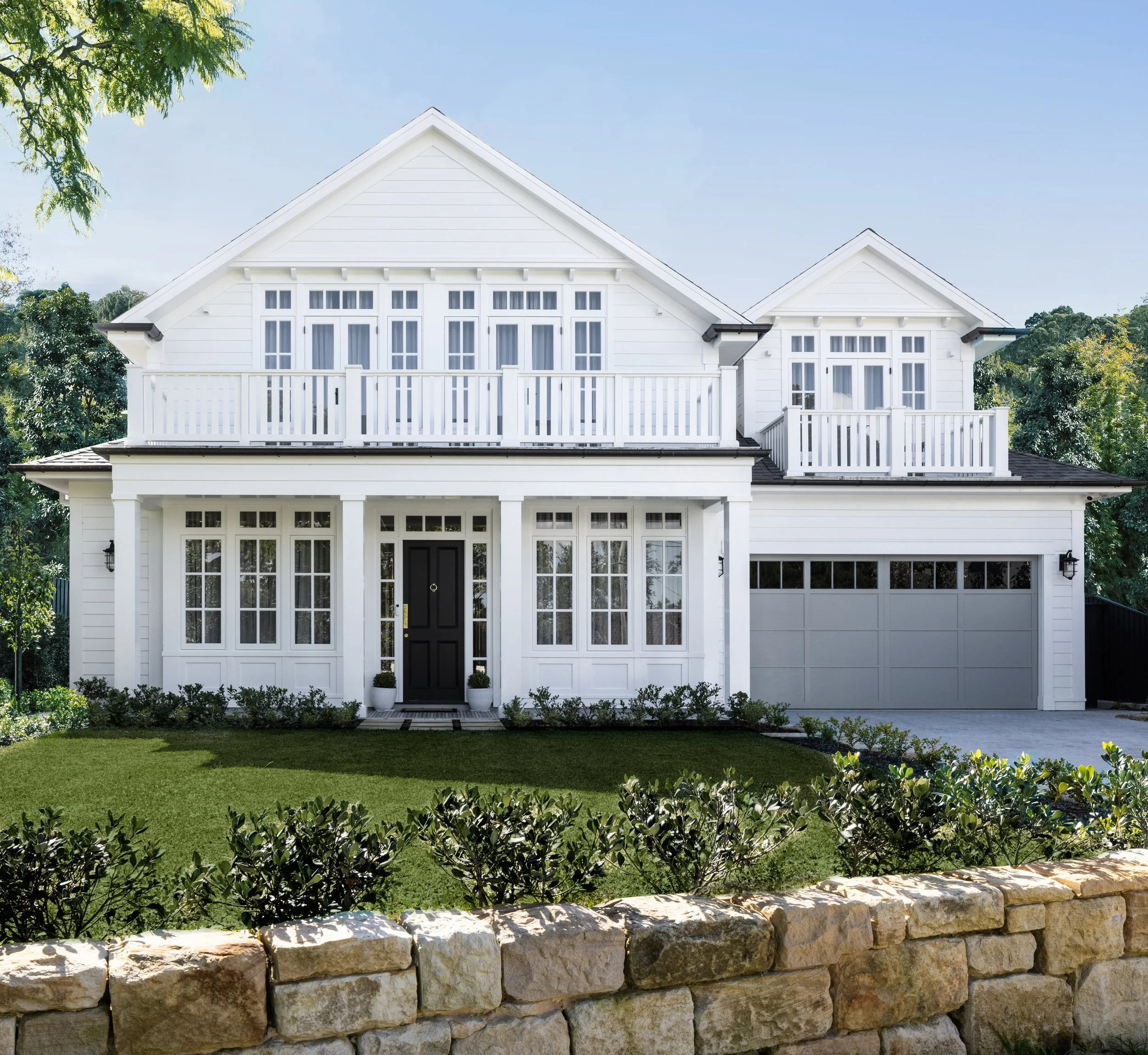 Blending layers of past and present. Salvaged sandstone blocks from the previous home were carefully repurposed, creating a retaining wall that anchors the new build in its history. House design by Alex Stritt. Project @strittdesignandconstruction. S