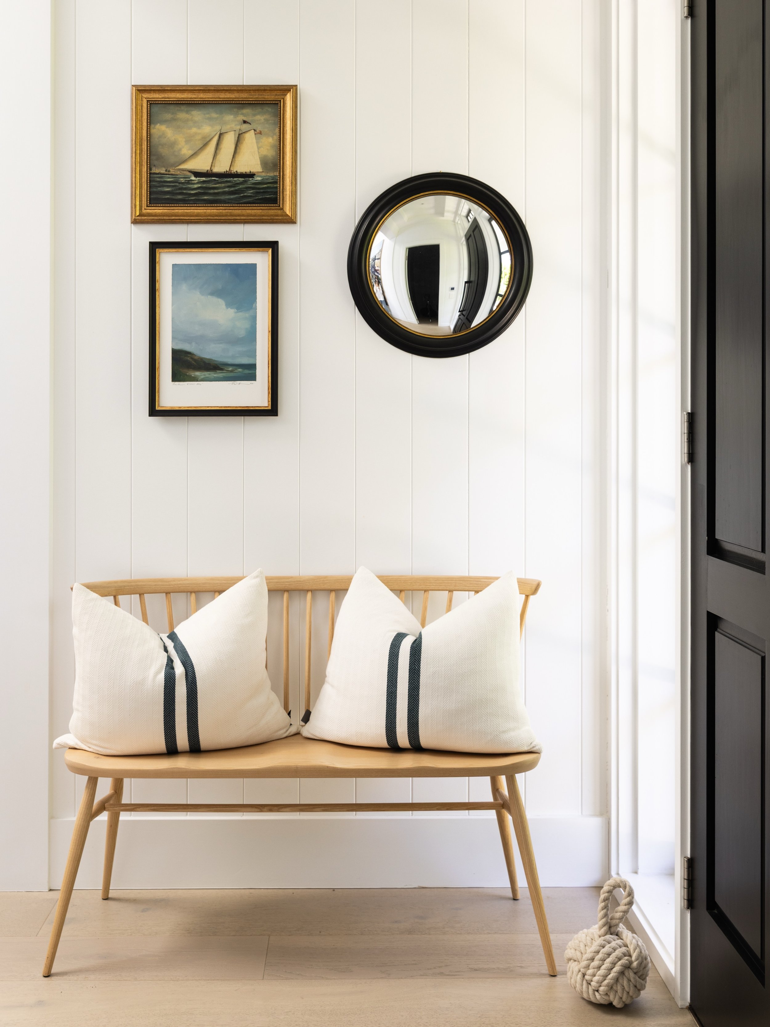 An @ercol_uk Originals Loveseat brings a warm and welcoming touch to the foyer, beautifully styled by our clients and made even sweeter by its two furry residents, Poppy and Archie 🤍. &lsquo;Southern Cross Sky&rsquo; painting bottom left by @natande