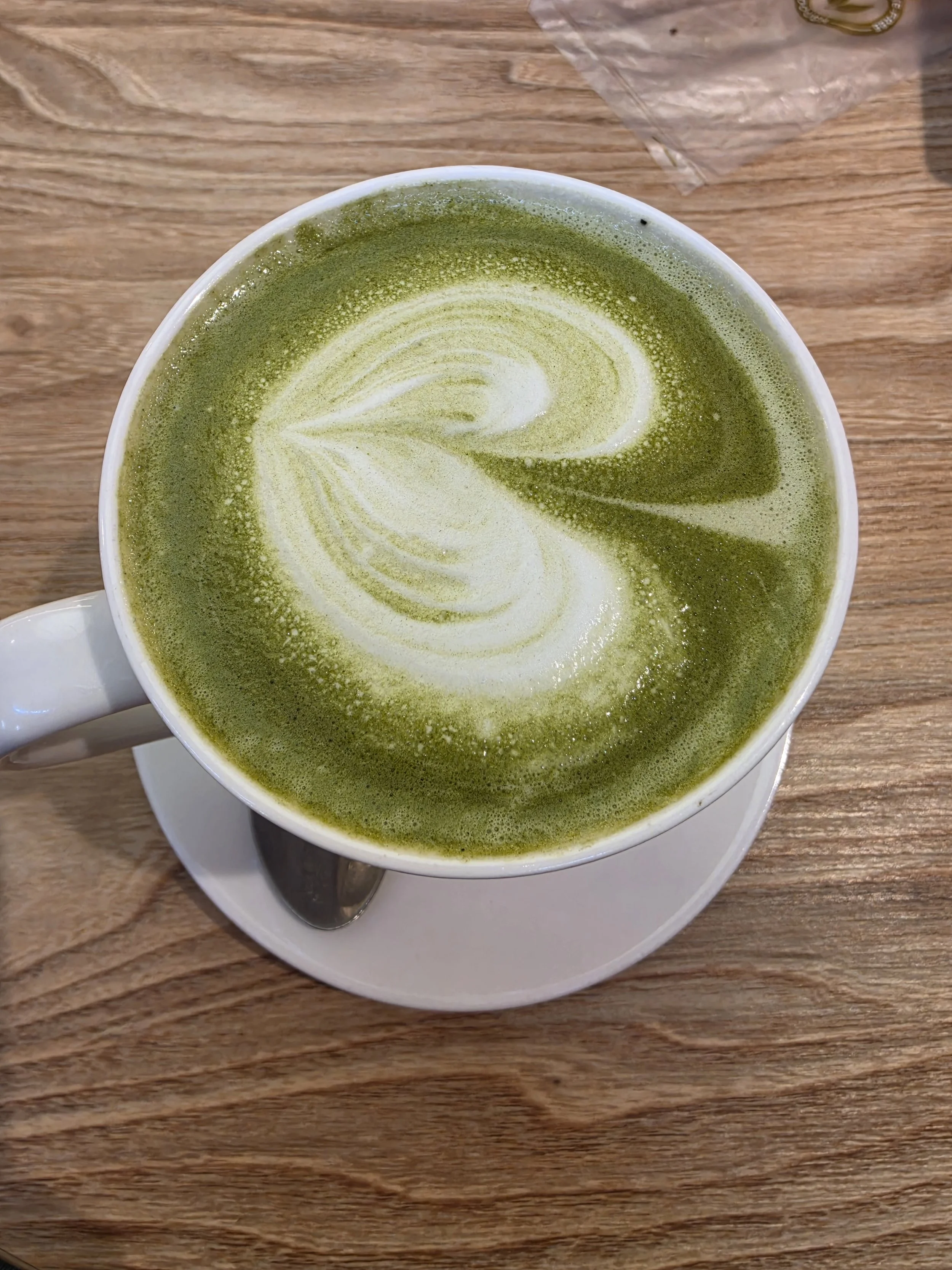 Matcha latte in a mug, a cozy low spoon drink.