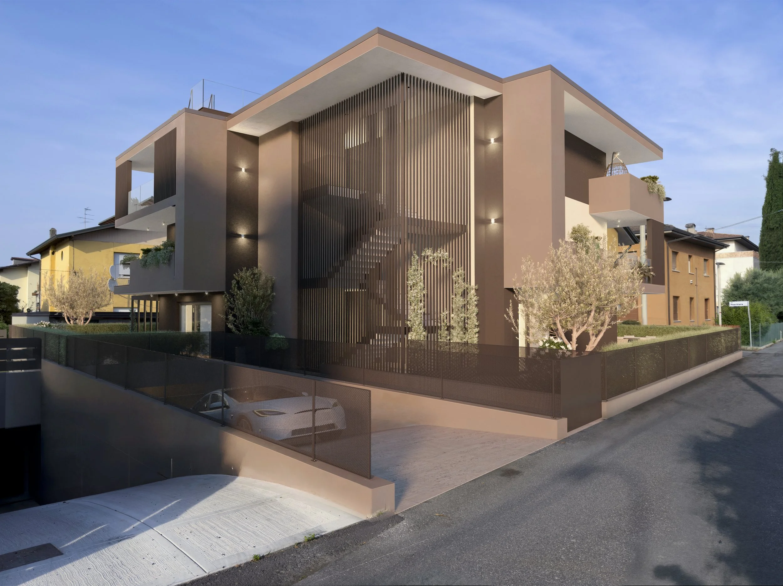 Modern multi-story residential building with beige and dark gray exterior, featuring large vertical wooden slats on one side, balconies with plants, and a fenced driveway with a white sports car parked under a ramp.
