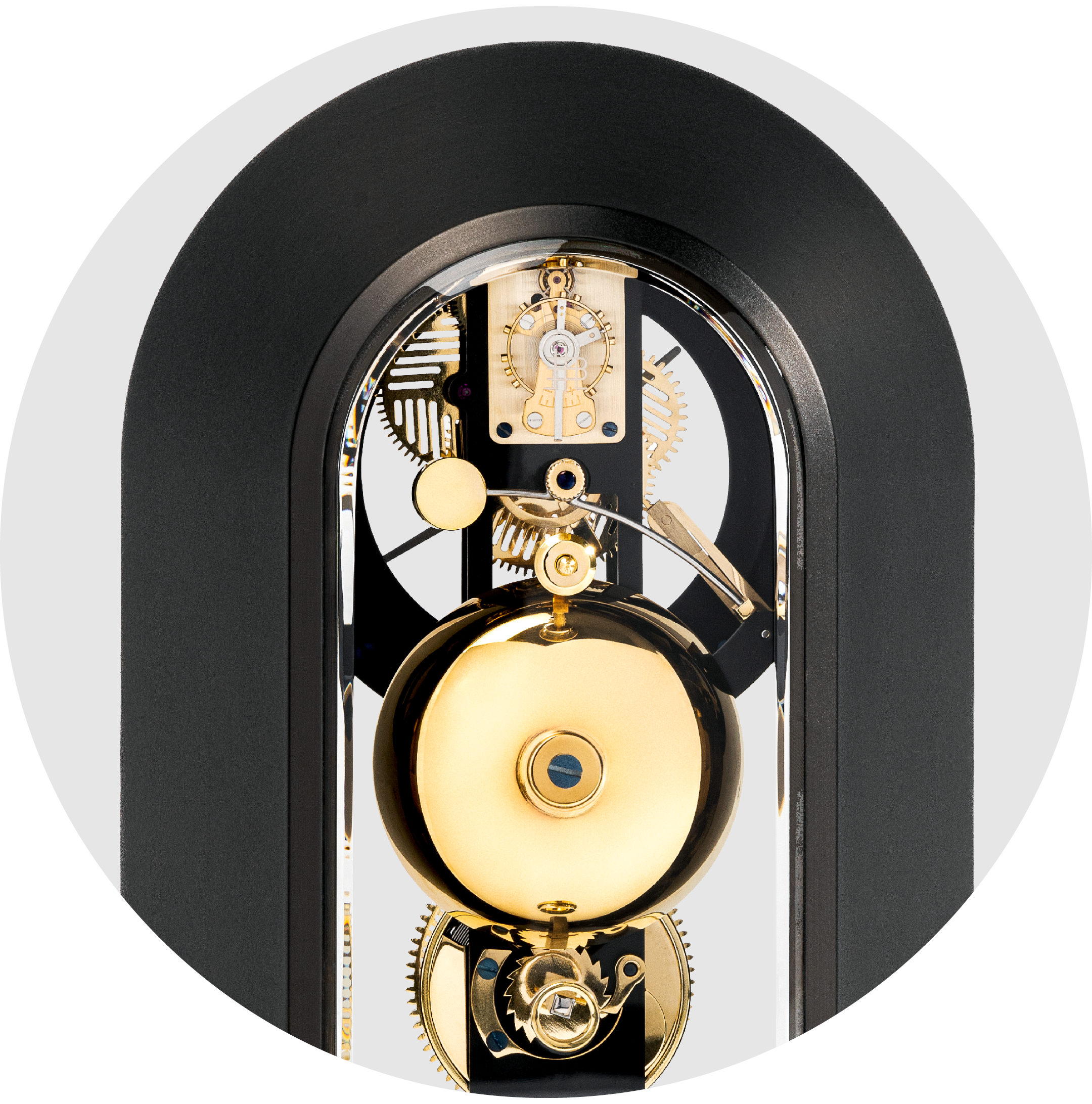 Close-up of a modern mechanical clock showing gears and internal components with a black and gold color scheme.
