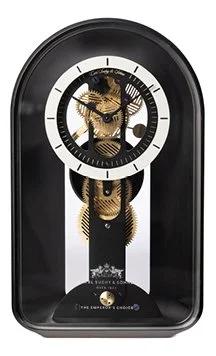 Black pendulum clock with a skull design on the face and decorative elements inside