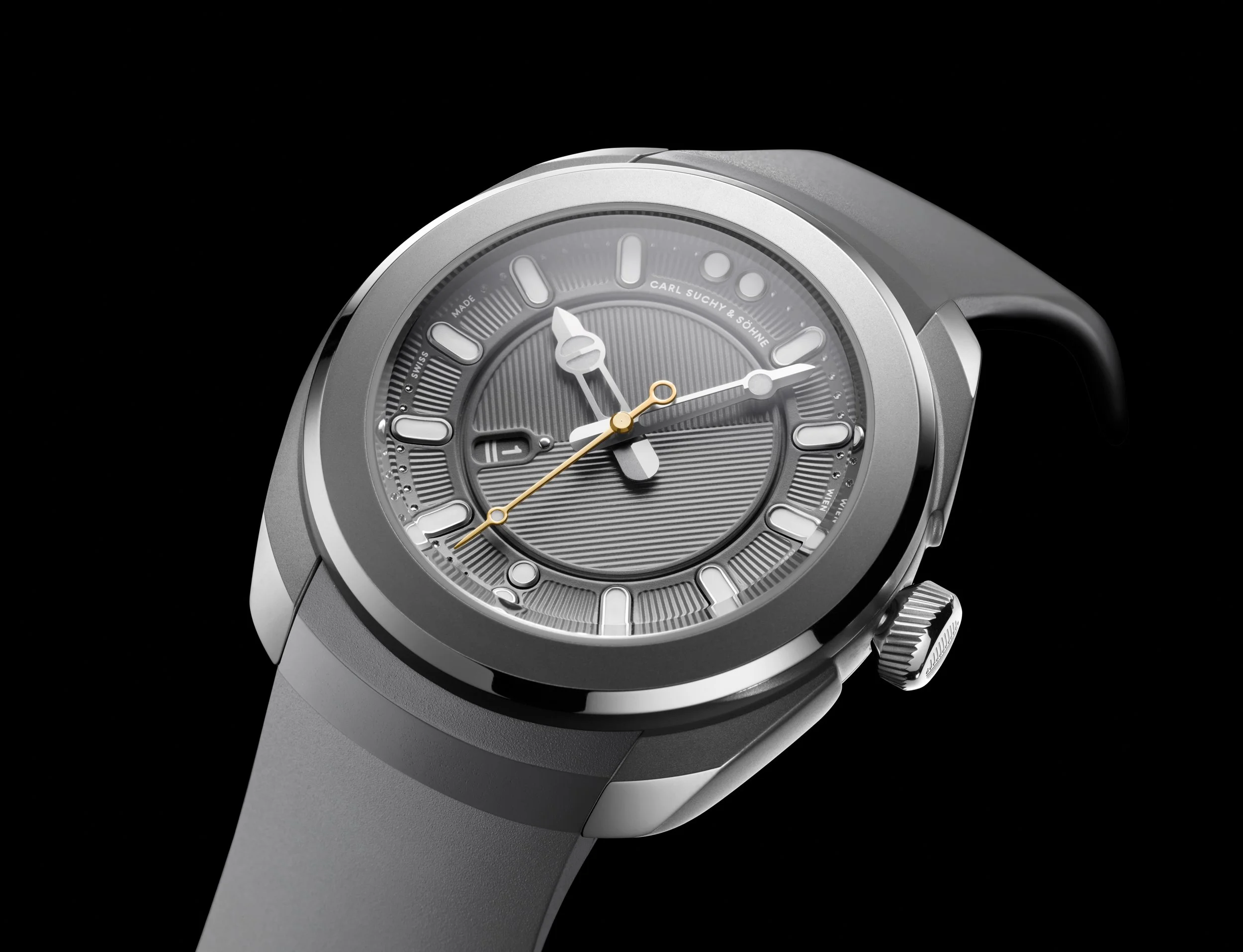 Close-up of a modern wristwatch with a gray face, silver casing, and gray strap, set against a black background.