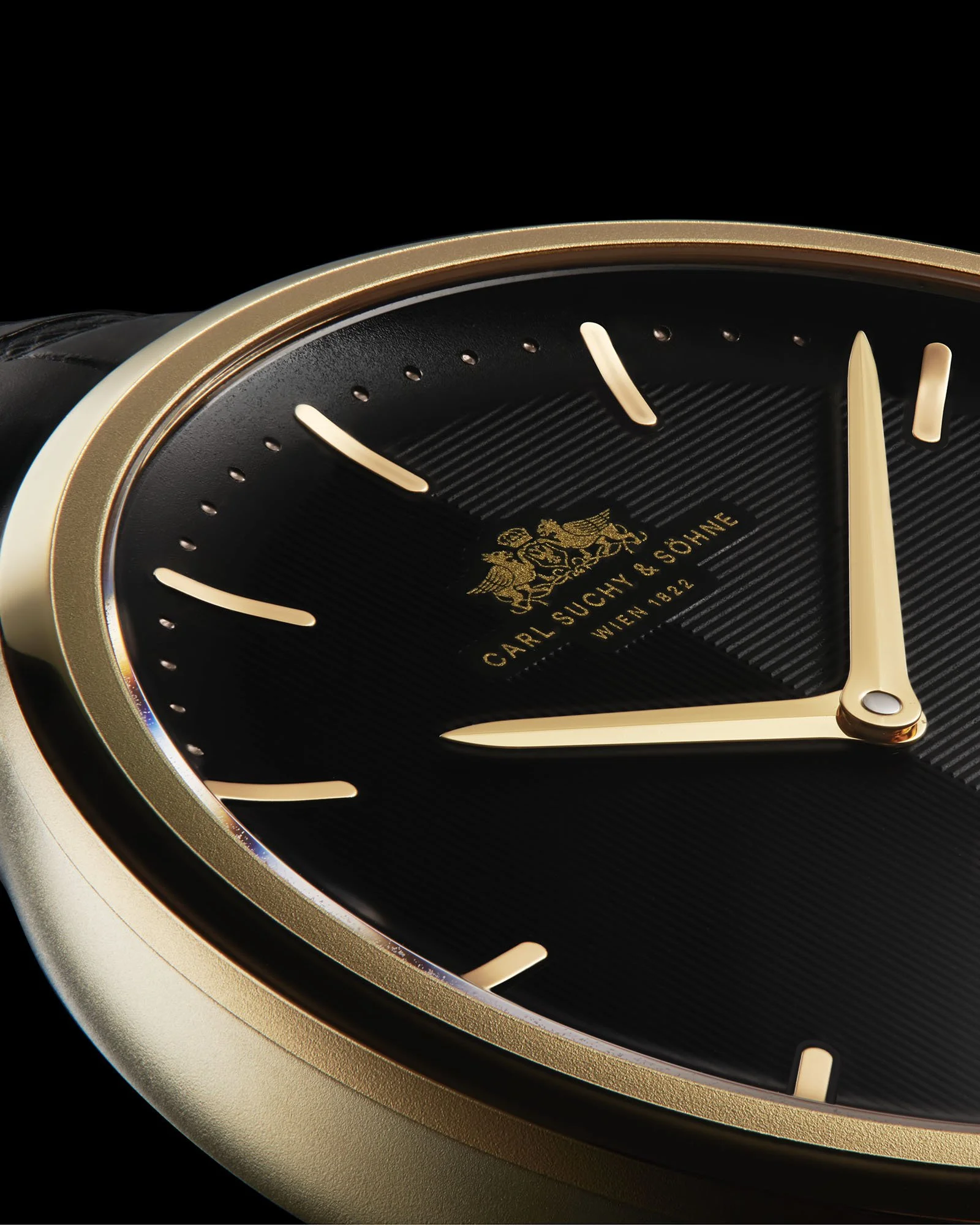 Close-up of Waltz Nº1 Gold wristwatch with a gold bezel and black dial, showing the time as approximately 8:14.