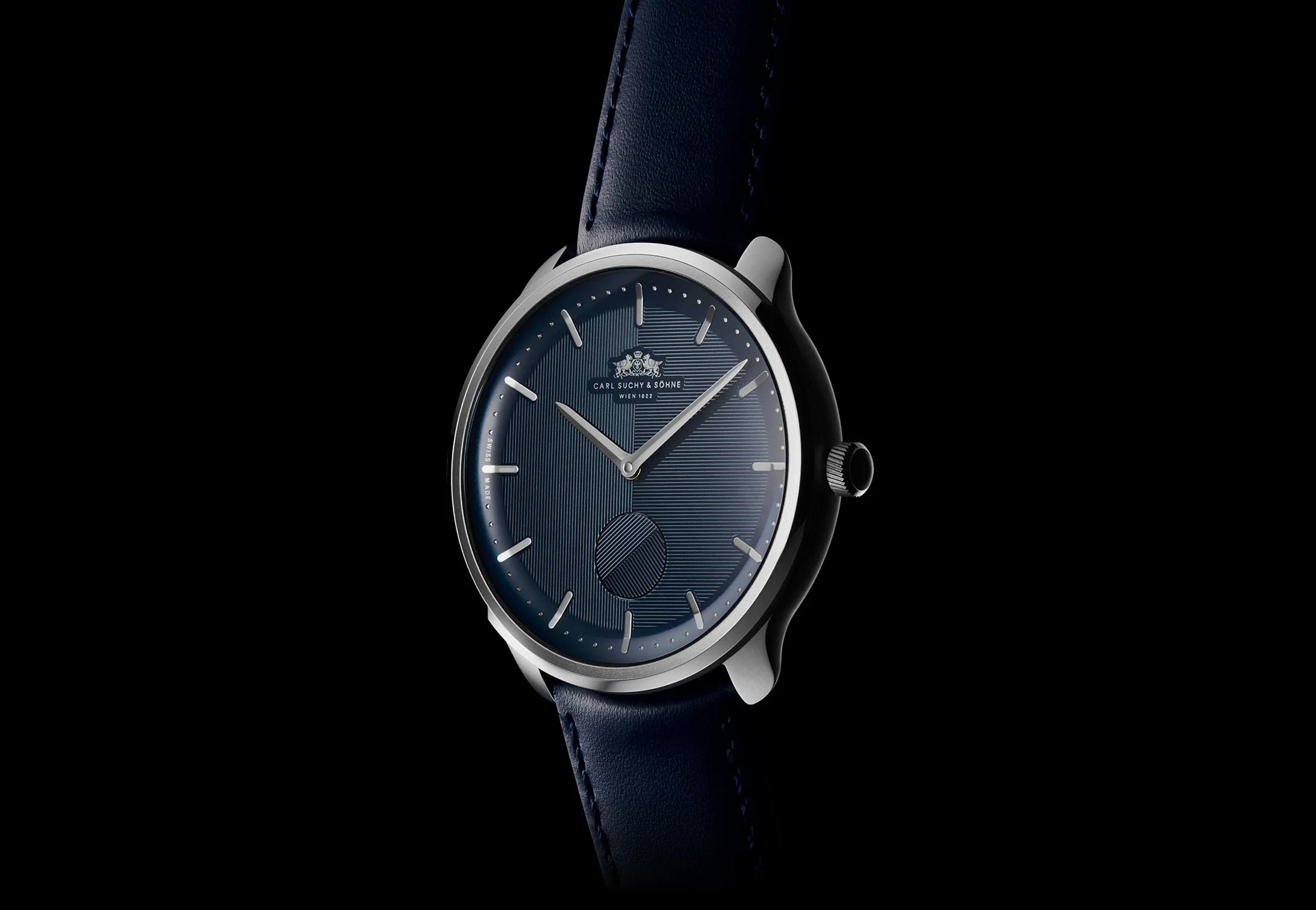 A luxury Waltz Nº1 with a blue dial, silver case, and blue leather strap, featuring minimalist hour markers and a logo at the top.