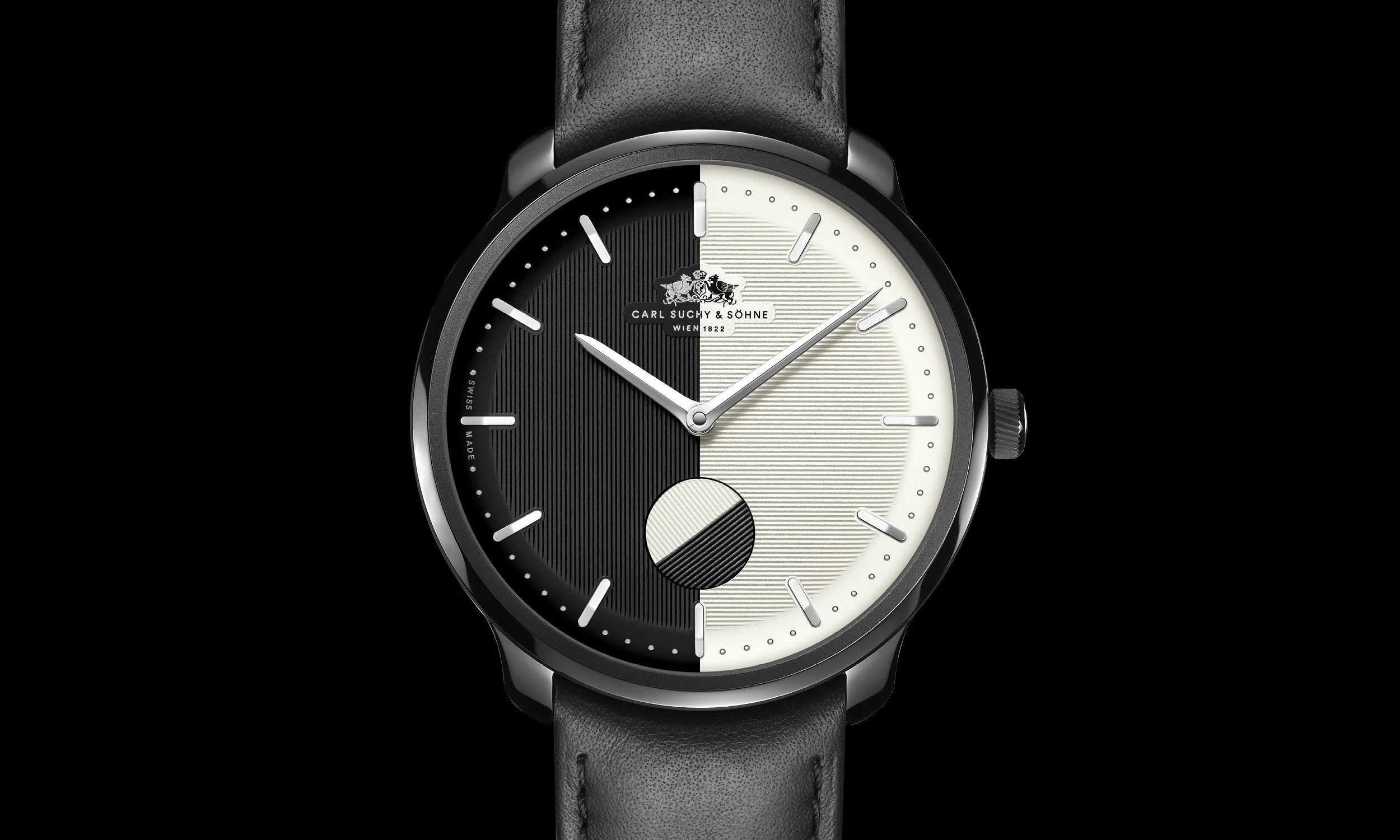 Black and white Carl Suchy & Söhne wristwatch with a leather strap, featuring a half-black, half-white dial, silver hands, and a diamond-shaped second hand, set against a black background.