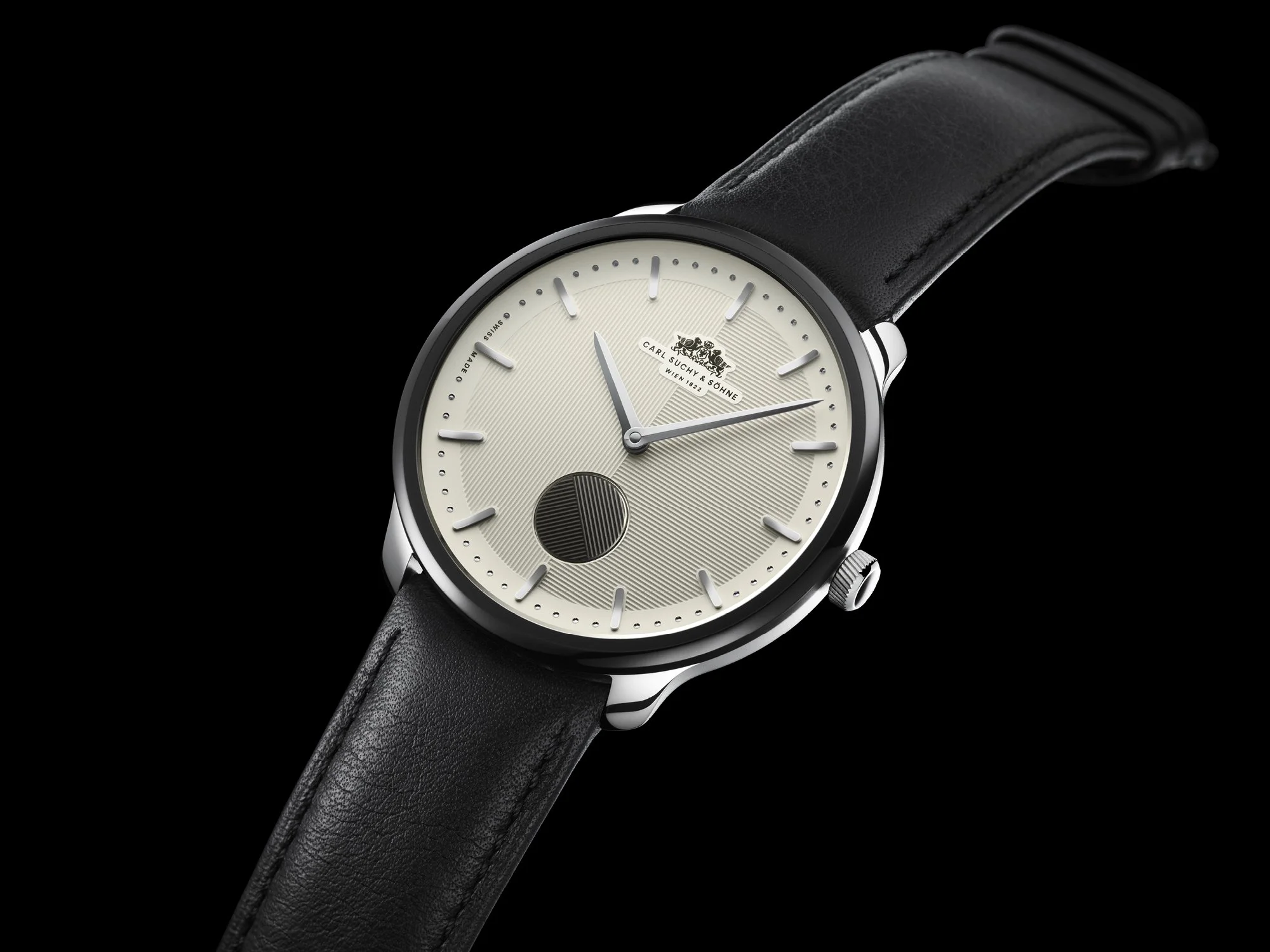 A luxury wristwatch with a black leather strap, white dial, silver case, and minimalist design.