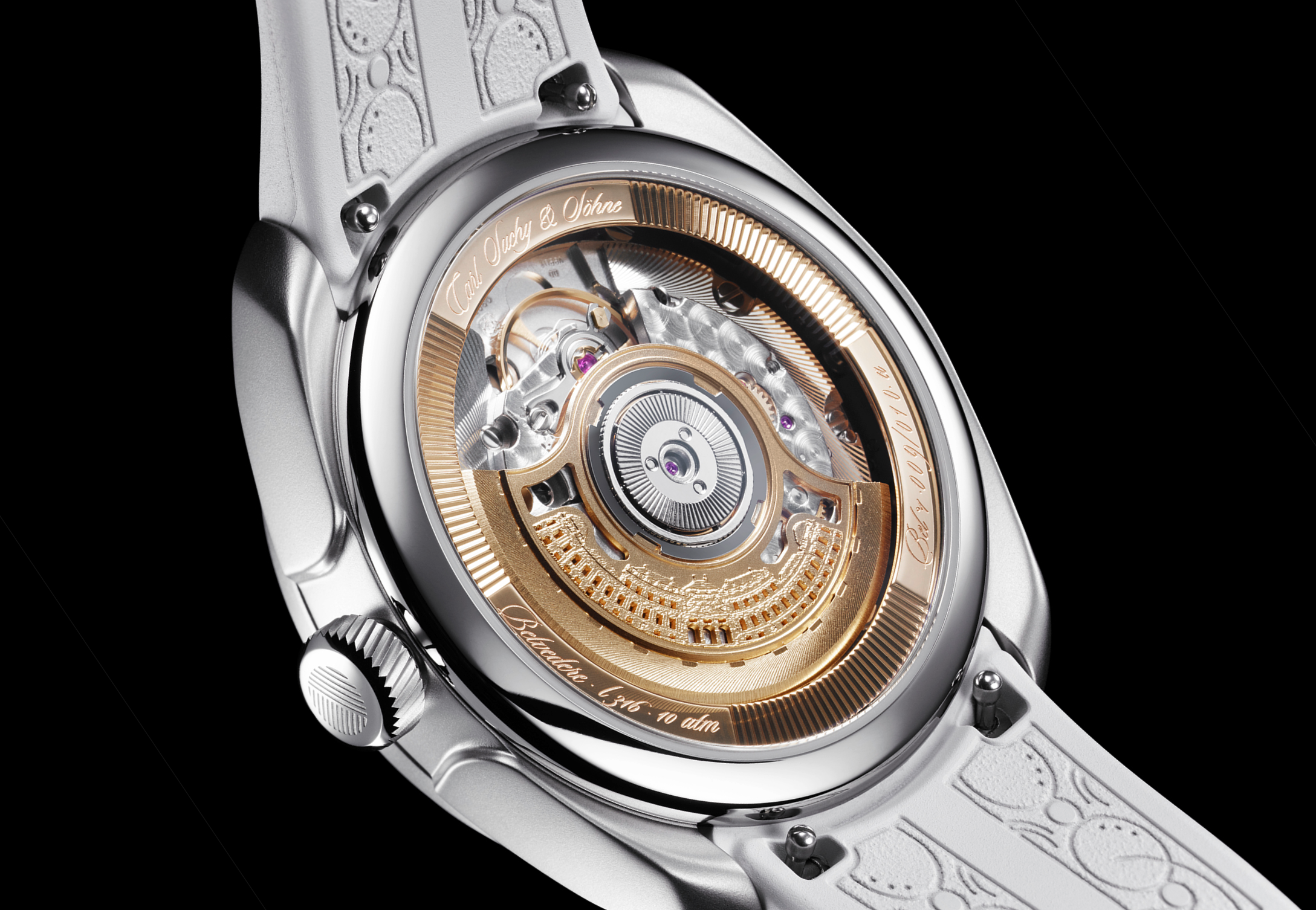 Close-up of a luxury watch with a visible intricate mechanical movement, featuring a gold rotor and engravings, mounted on a white strap with embossed patterns.