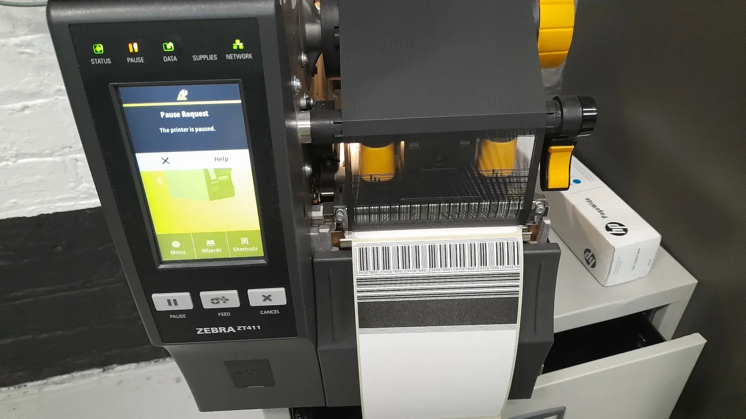 Engineer testing barcode label printer after repair