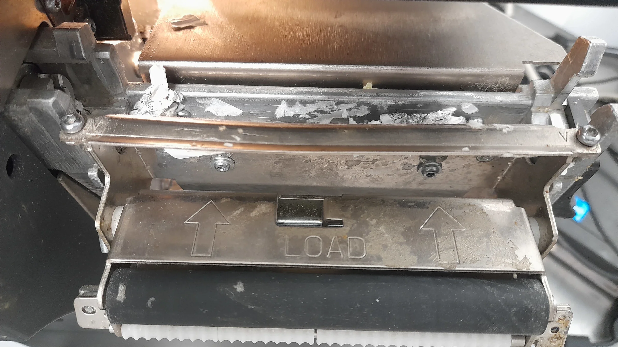 Engineer carrying out label printer maintenance on a Zebra ZT411