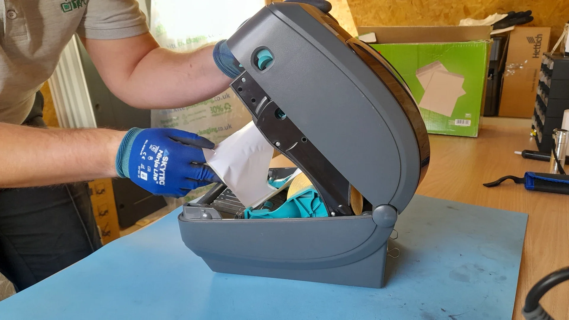 Zebra printer repair specialist carrying out on-site repair of a Zebra label printer in the UK.