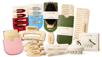Collection of soap bars, hairbrushes, and grooming accessories arranged on a green surface.
