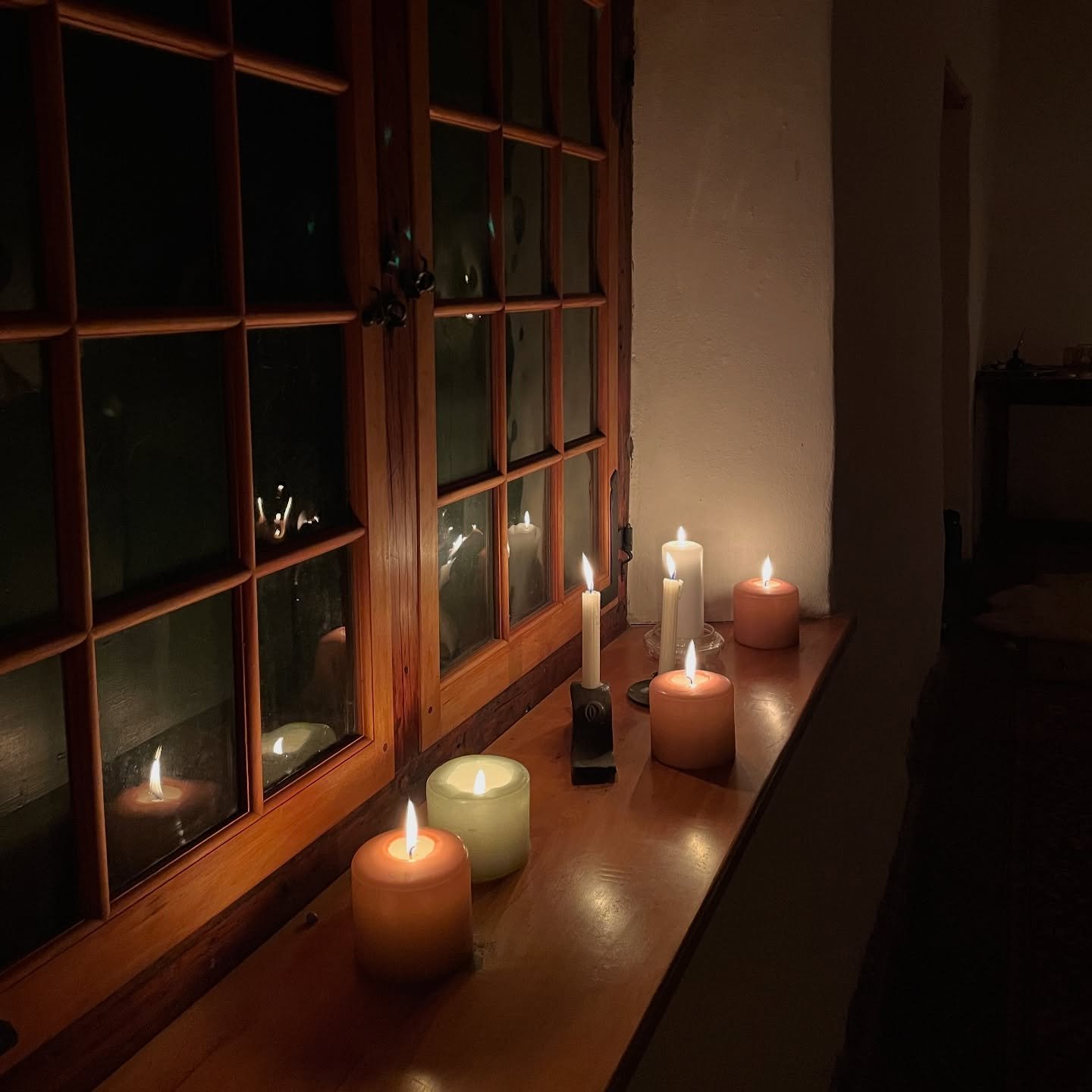 Step through the door of this 200-year-old barn.

Here, you are met with light
that has been gifted 
by the flames of many candles
lining the ledges of these old walls.

Incense meets your nose,
guiding you toward the carpets, 
lovingly laid to make 