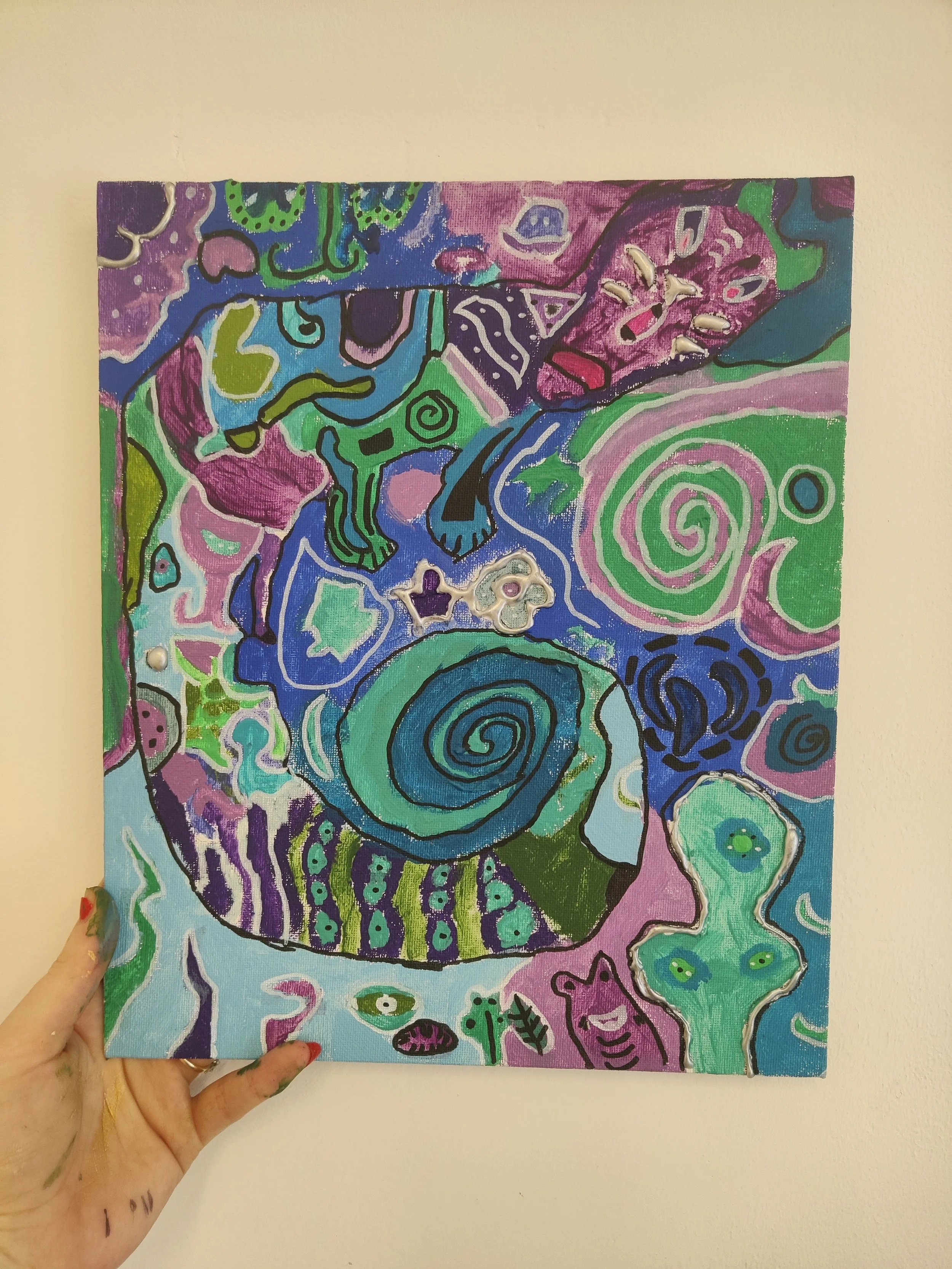 Colorful abstract painting with swirling patterns, animal figures, and vibrant colors including purple, blue, green, pink, and black.