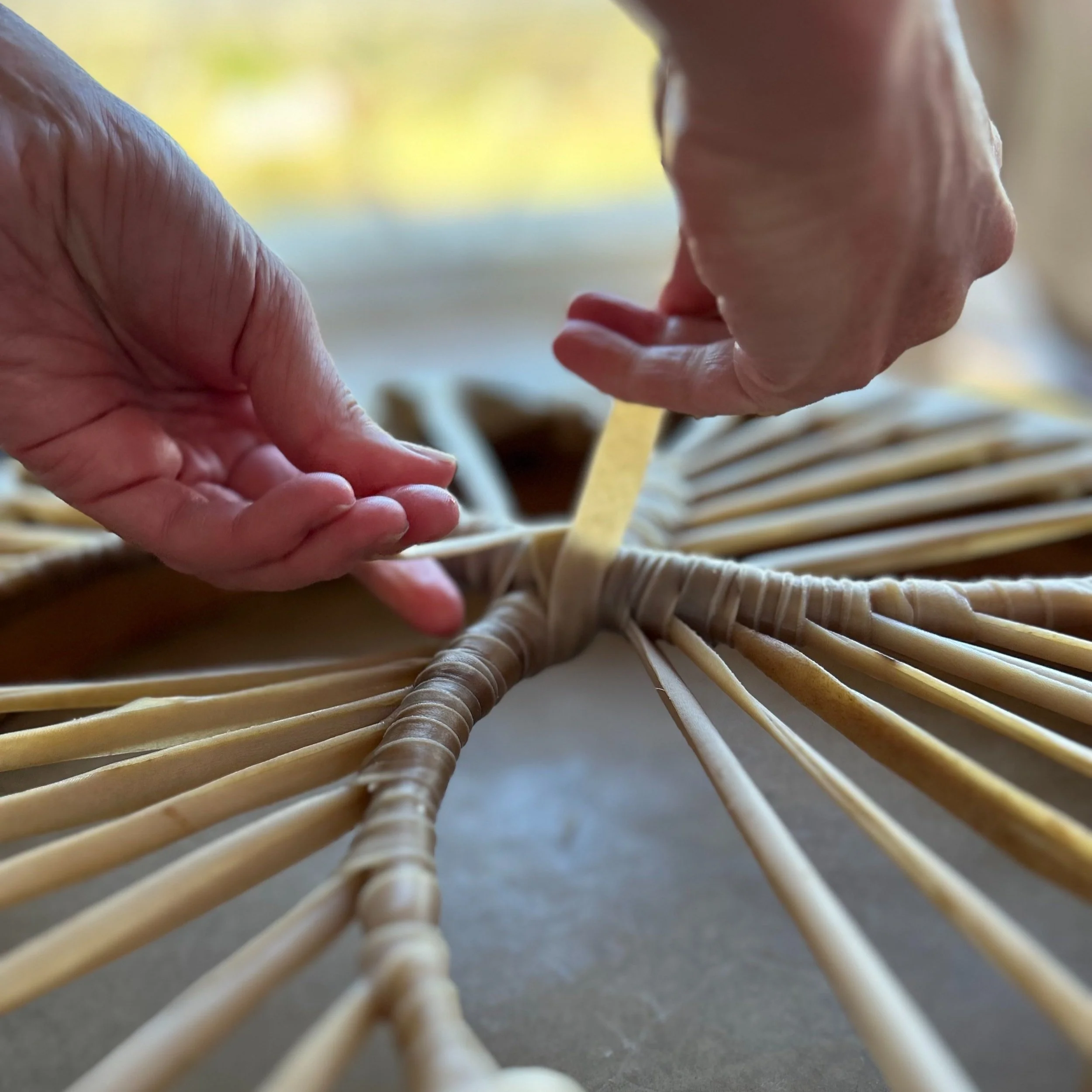 Close-up of hands creating a handmade drum.
