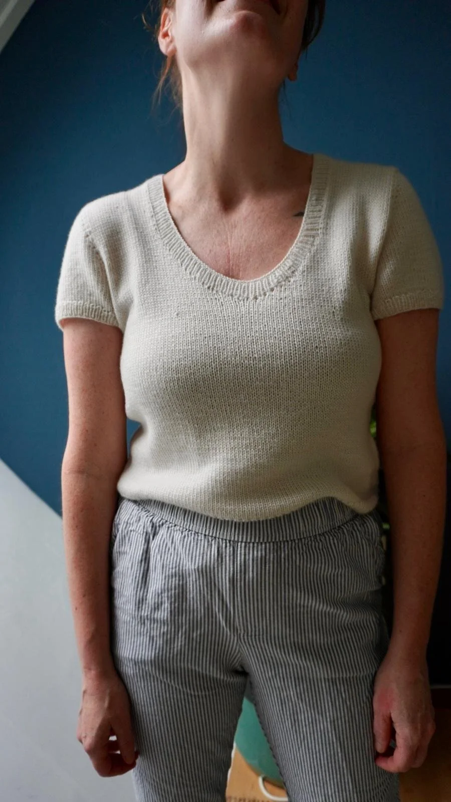 Woman wearing the Cashmere outside tee from Arly Knits, looking up