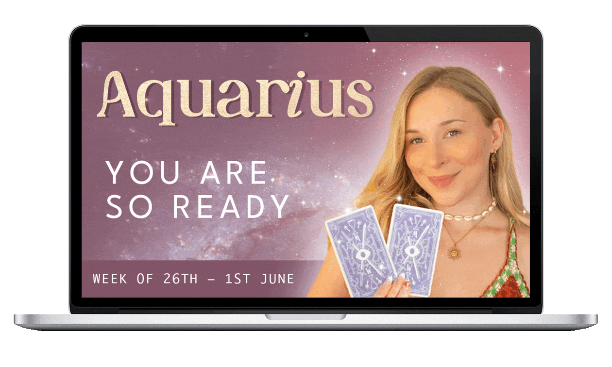 Laptop screen displaying an astrology forecast for Aquarius with the text "You are so ready" and a woman holding tarot cards, against a starry galaxy background.