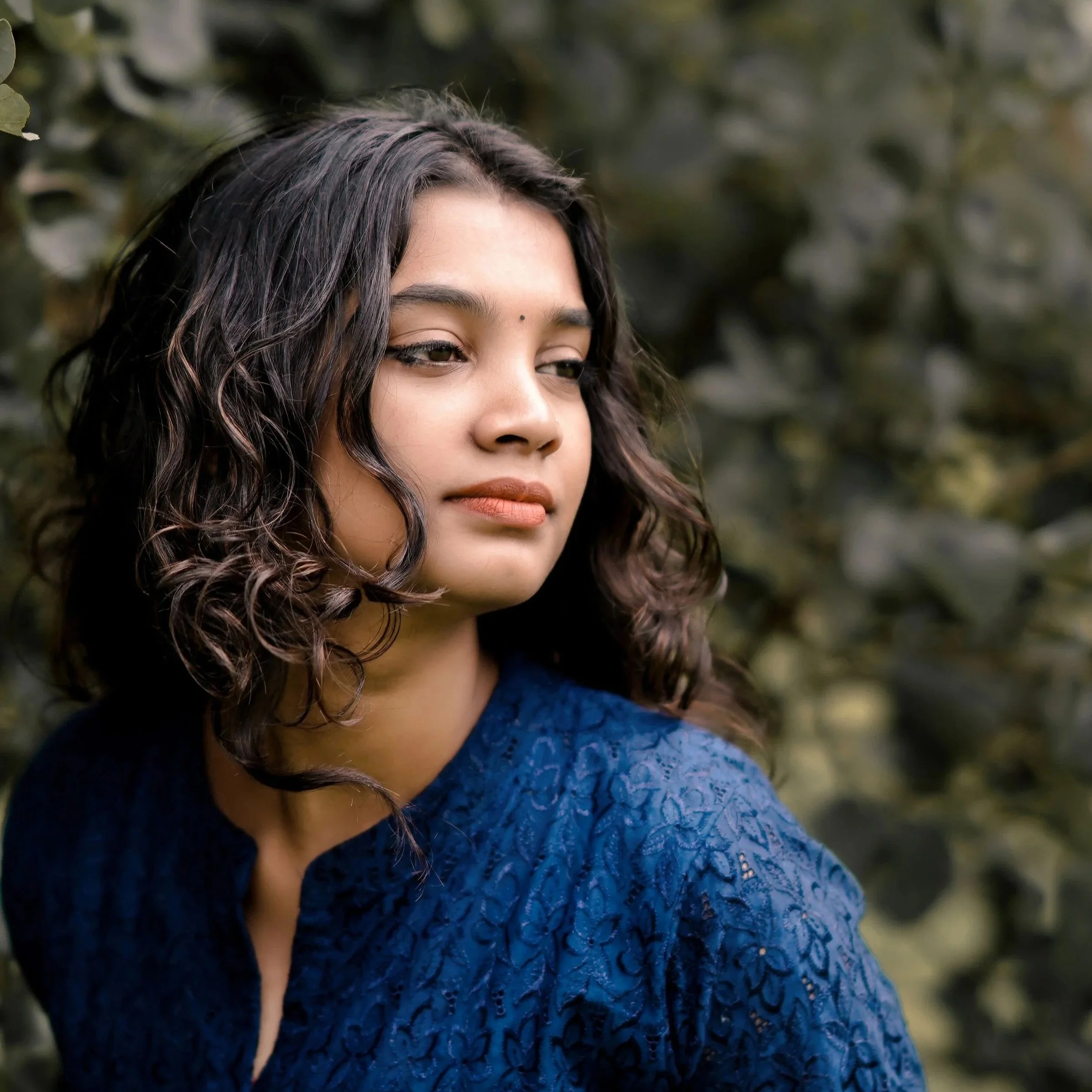 Woman with curly hair holding