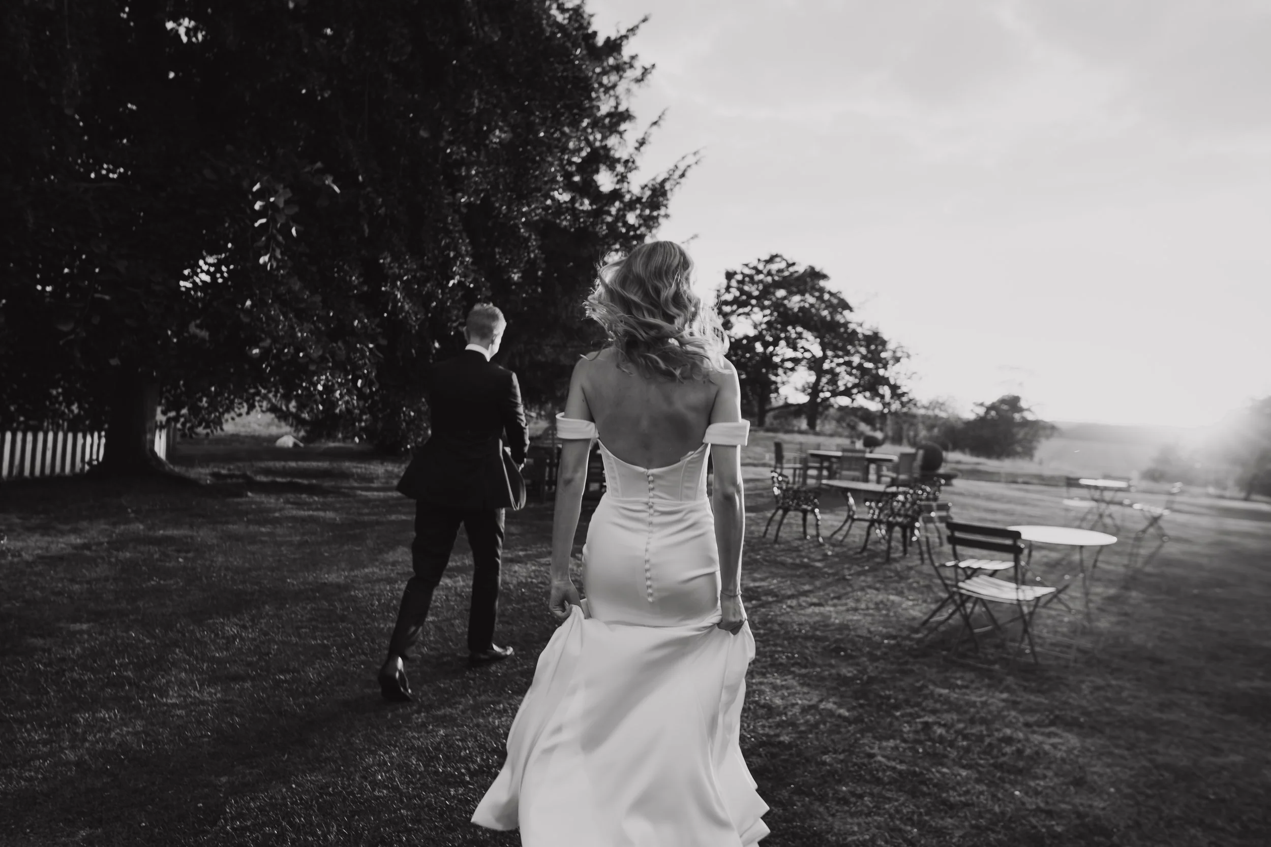 Black and white photograph of bride and groom chasing the sunset at Langar Hall