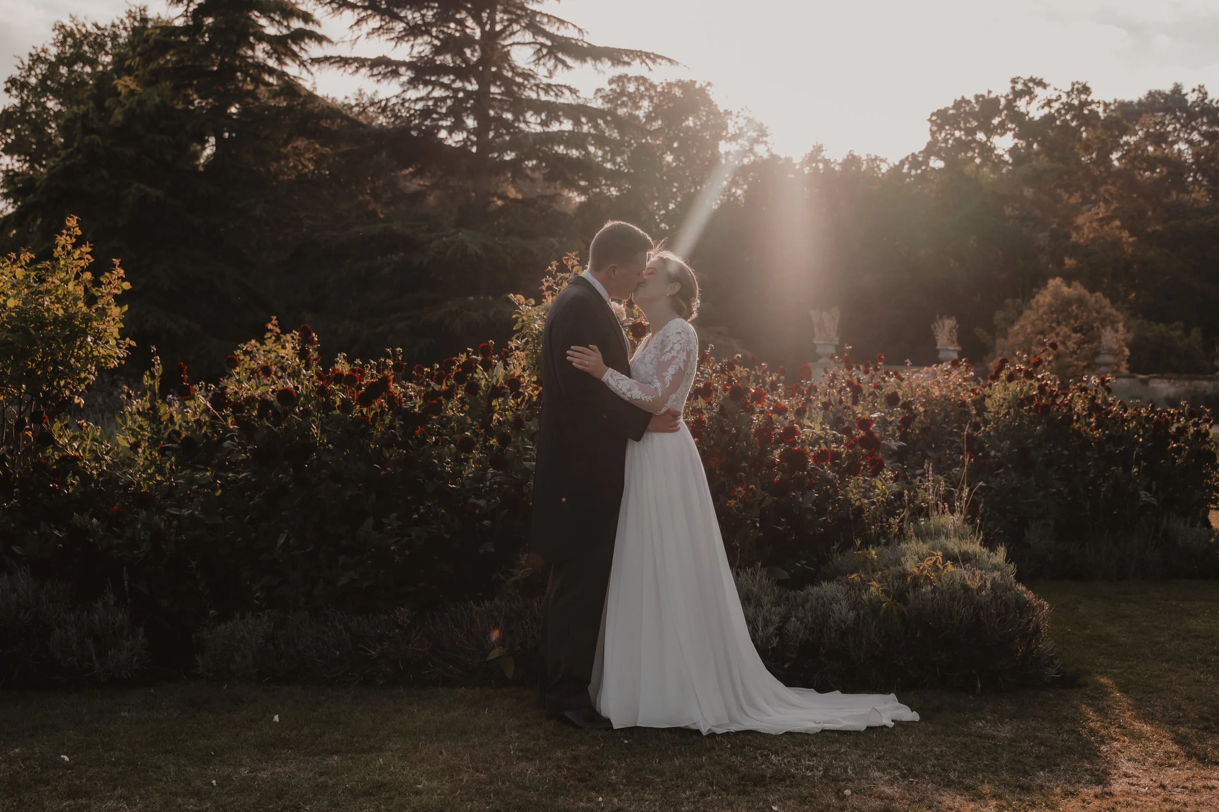 A bride and groom share a kiss at golden hour Preswold Hall