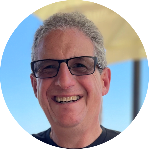 Lush tropical jungle with dense green foliage, large leaves, and sunlight filtering through the canopy.