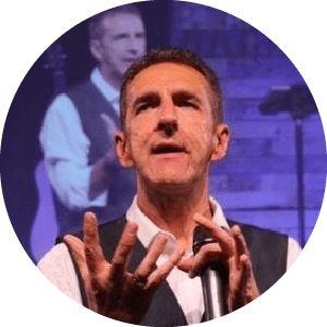 Lush green tropical plants and trees inside a greenhouse or conservatory.