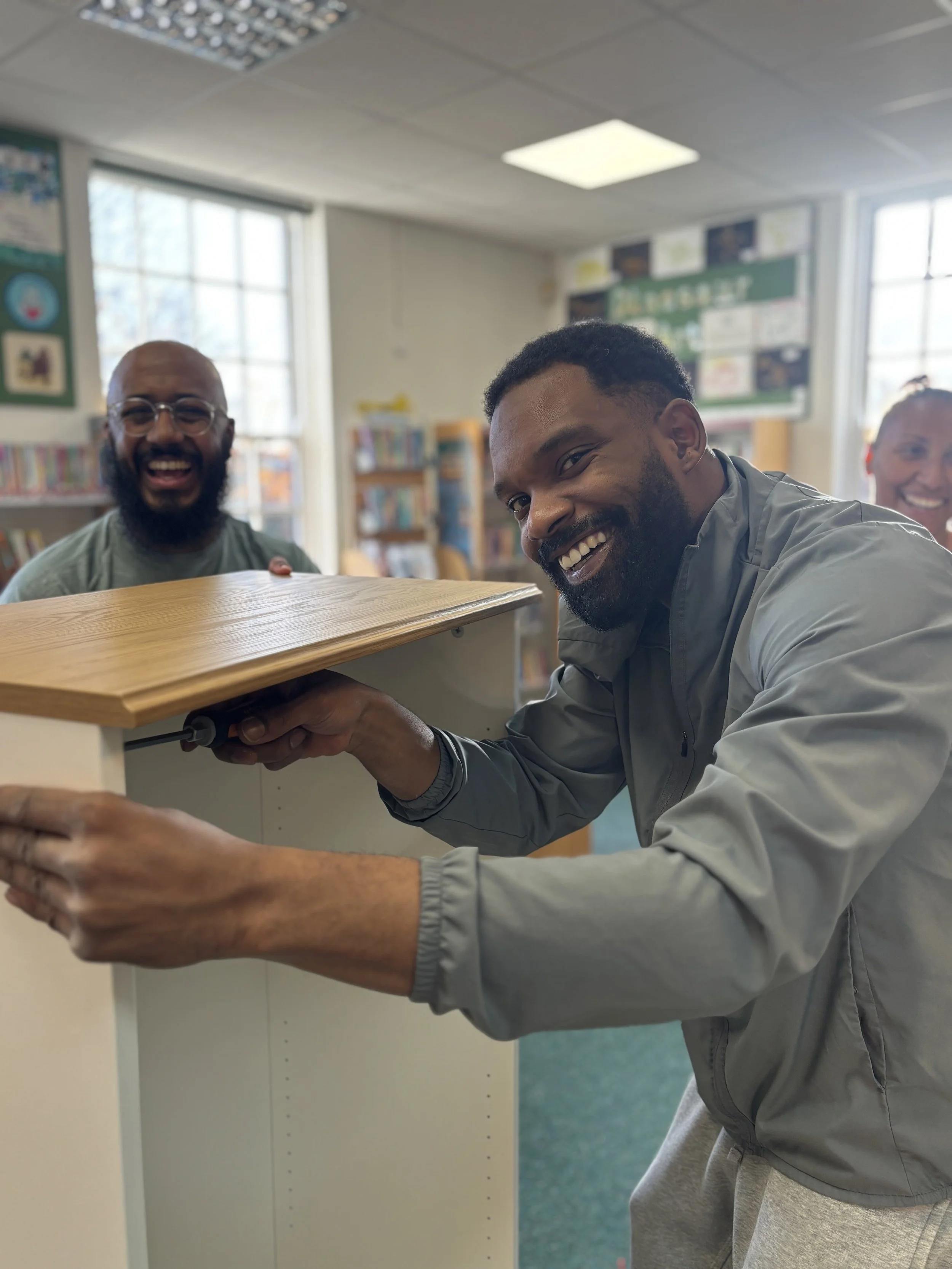 Smiling man building furniture