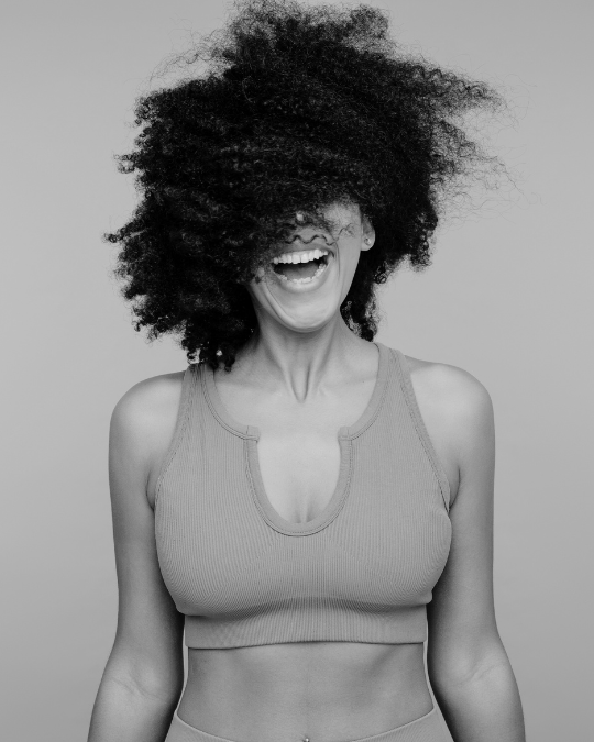 Woman happy after her breast augmentation a neutral bralette