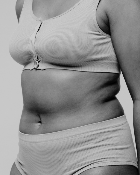 Womans body in neutral underwear
