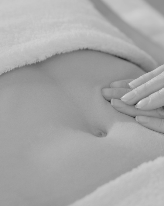 Womans stomach being checked by a consultant