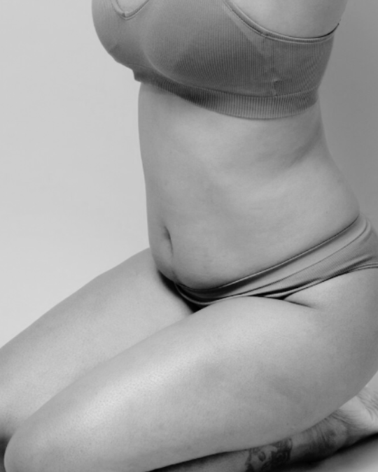 woman kneeling down in neutral underwear