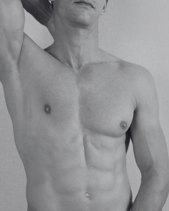 Upper body of a fit male with a well-defined chest and abdomen, representing typical aesthetic goals following male chest reduction surgery for gynaecomastia.