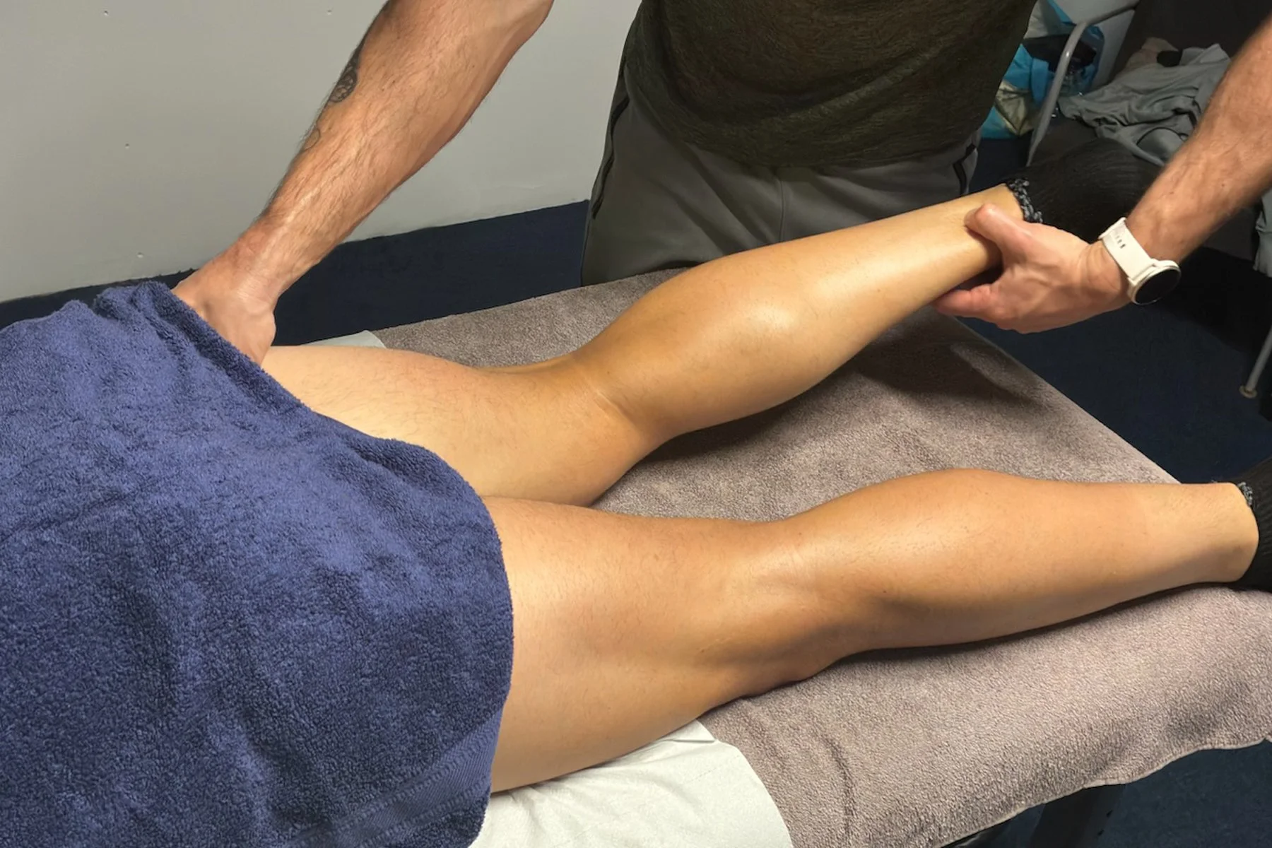 Person receiving sports massage focussing on their legs in Llantwit Fardre, Pontypridd, Wales