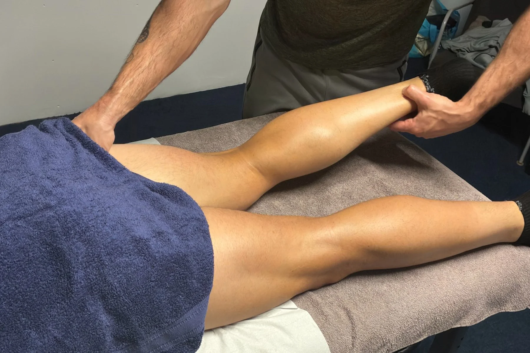 Person receiving sports massage focussing on their legs in Llantwit Fardre, Pontypridd, Wales