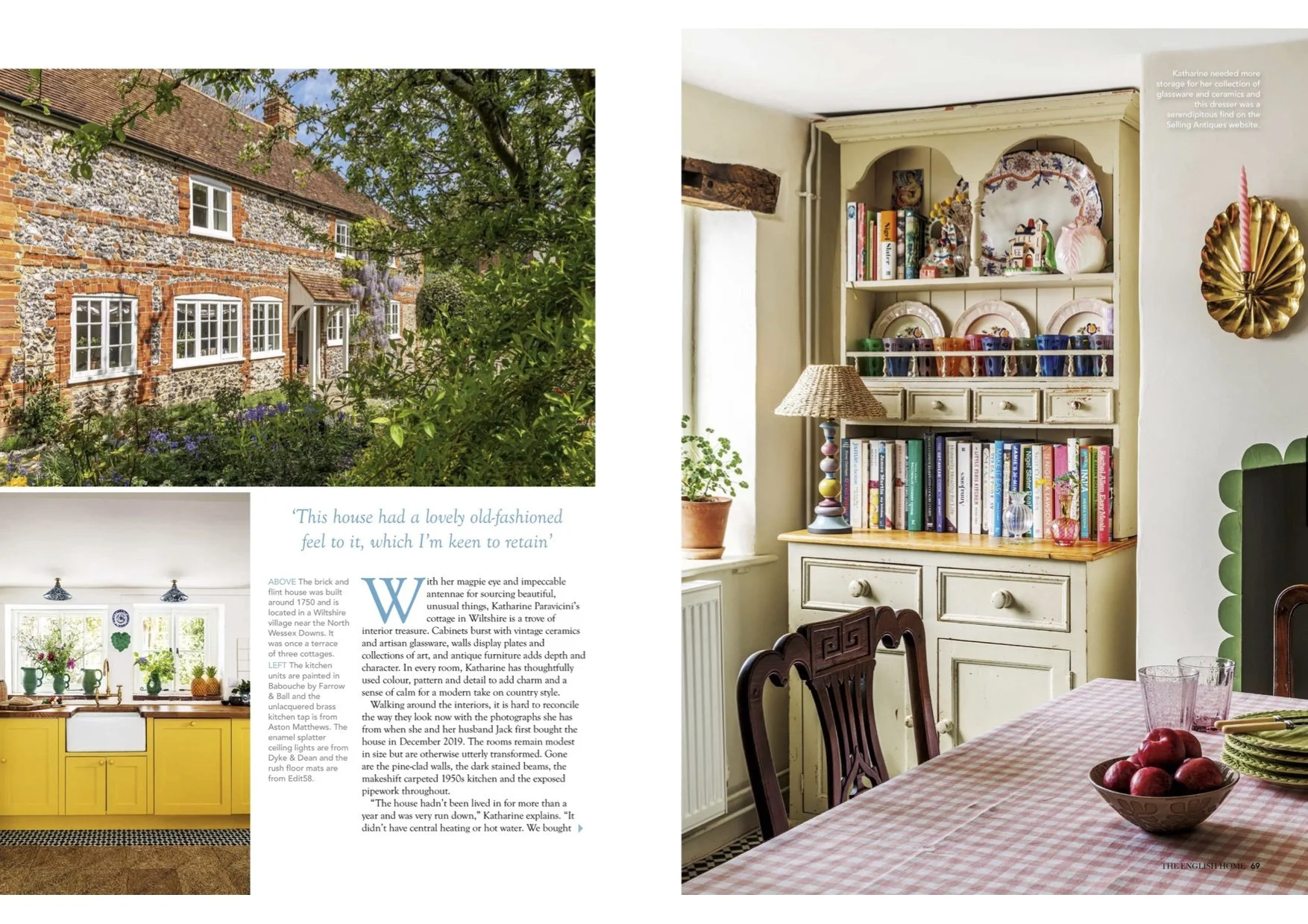 View of a traditional brick and flint house with multiple white-framed windows, surrounded by greenery and flowering plants, under a partly cloudy sky.