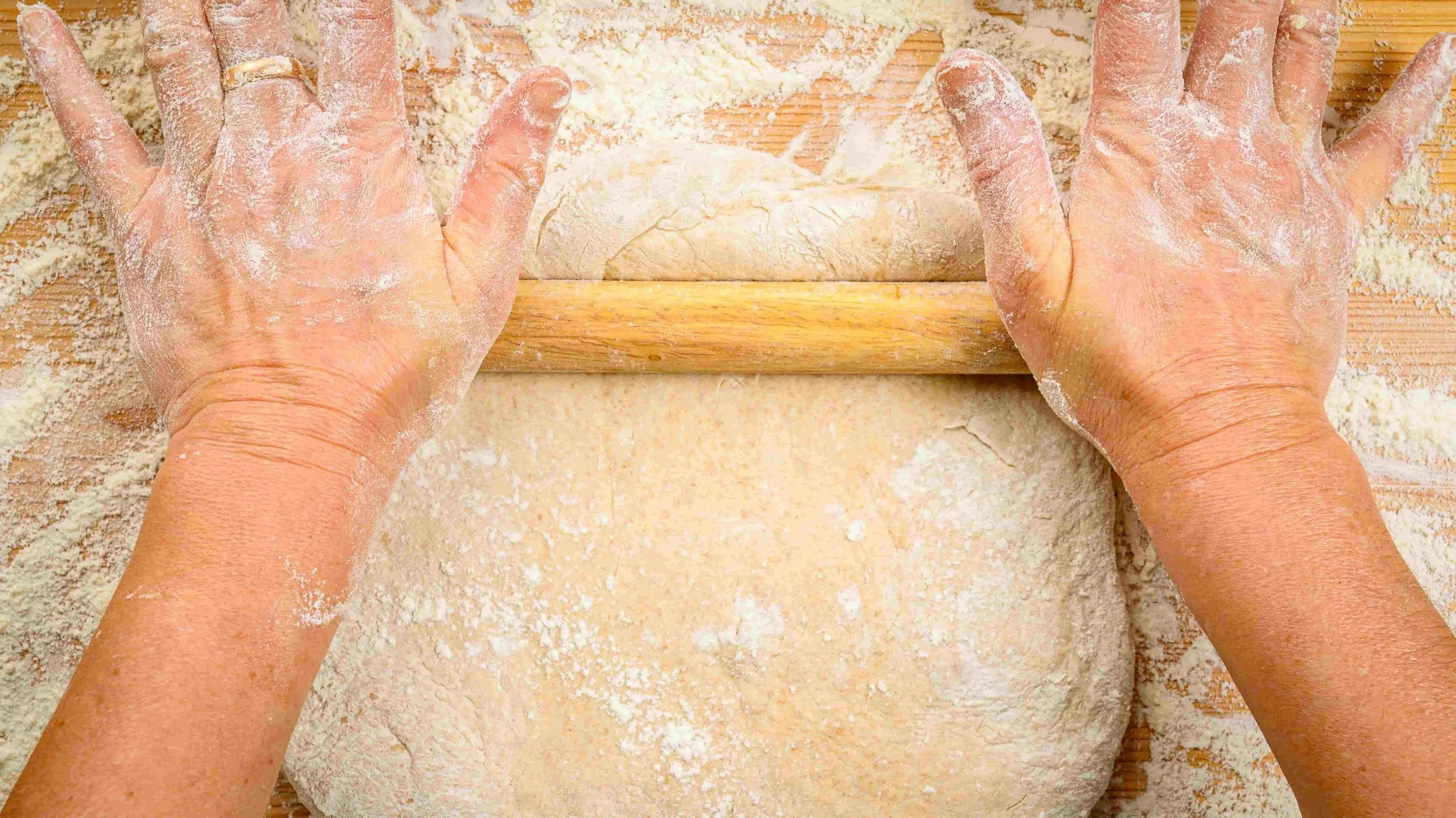 Women rolling out dough