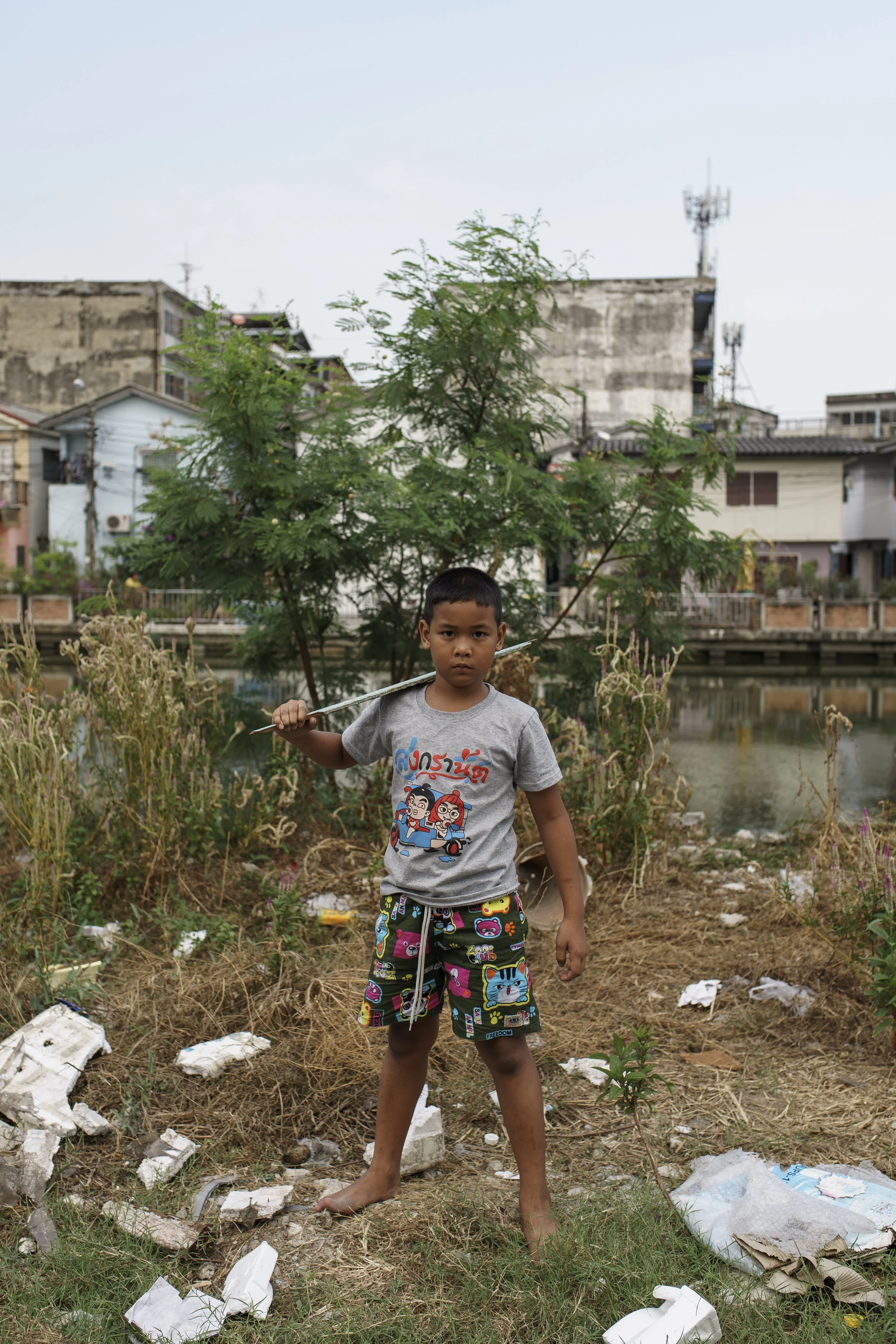 A boy posing for a photo while playing around the community