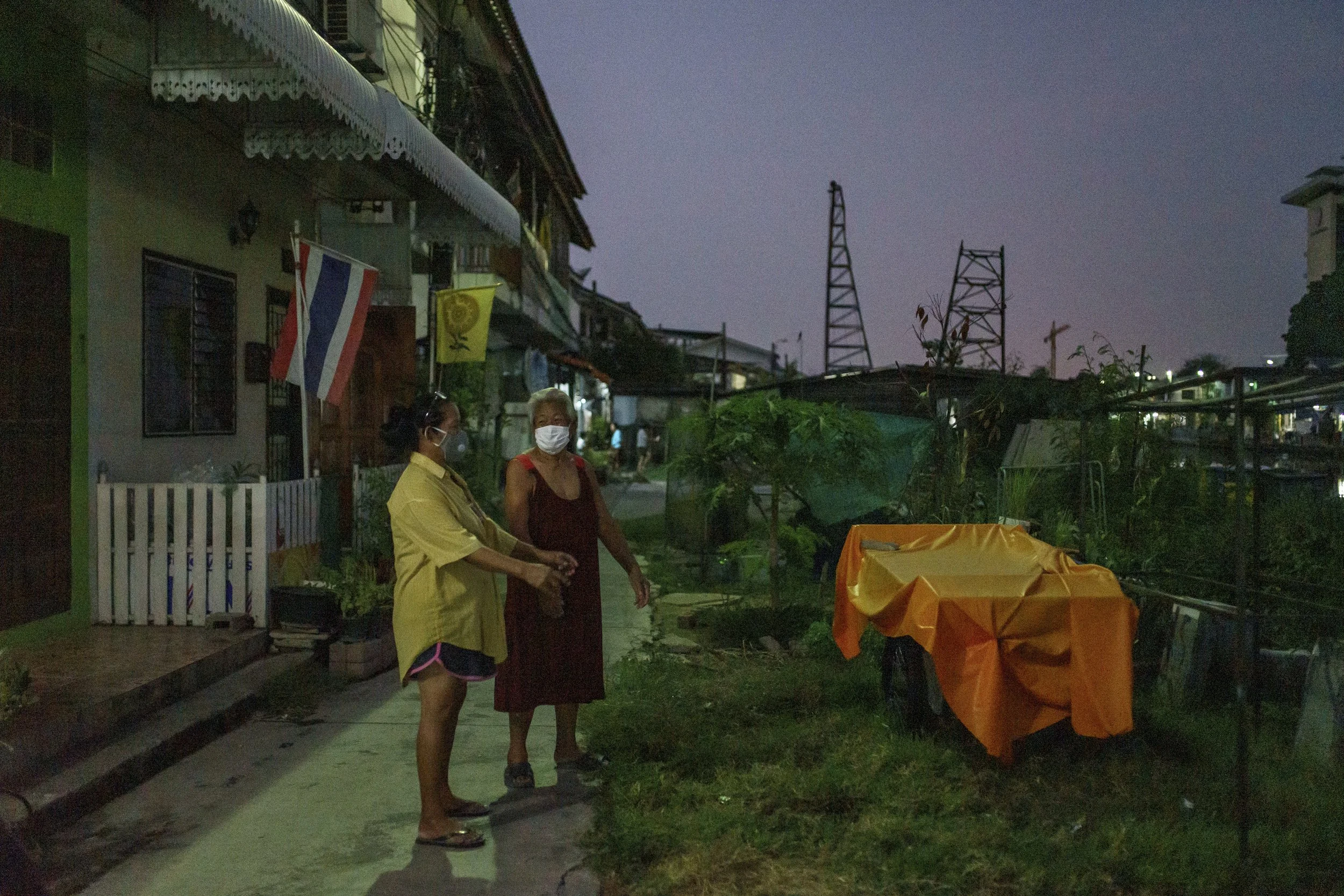 Usalak and her neighbor are relaxing in front of her house in the evening