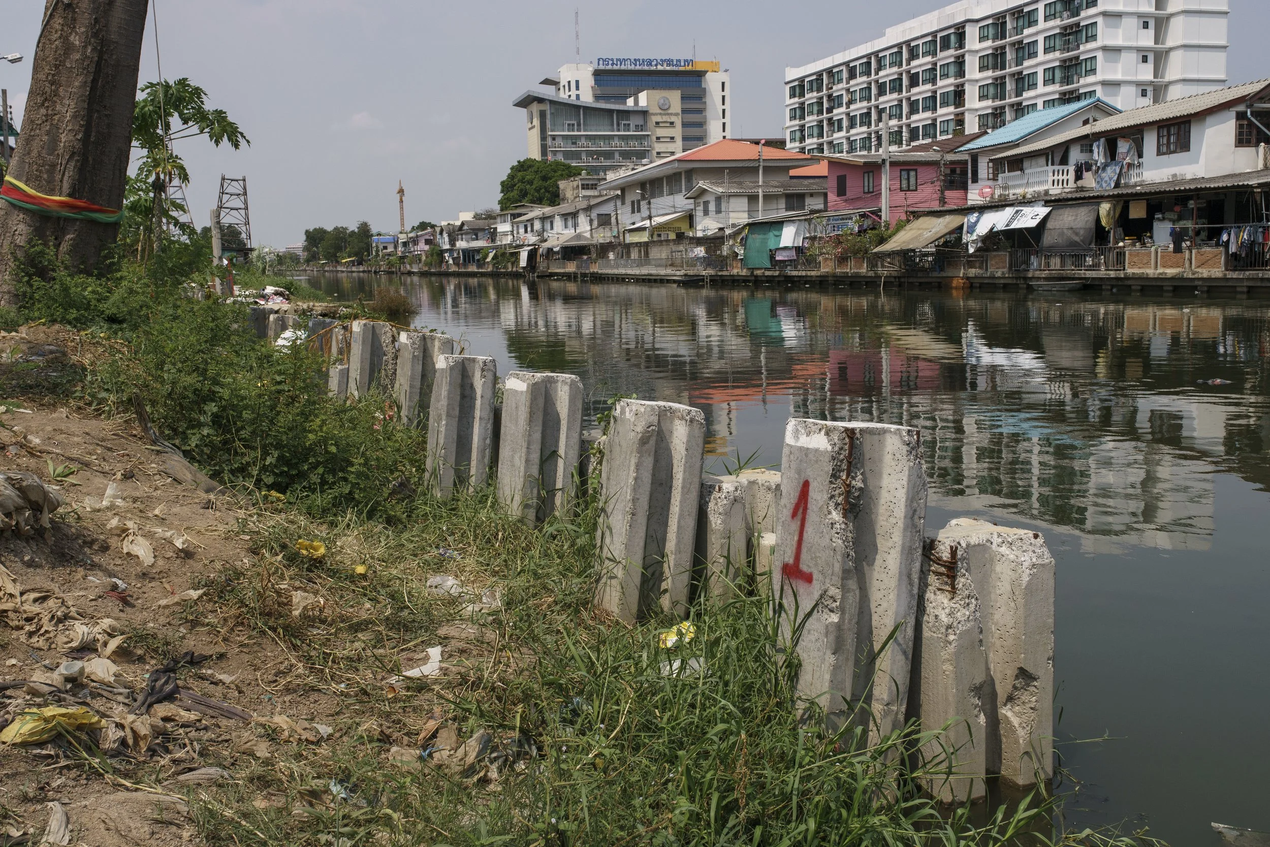 Pillars from an unfinished construction project can be seen alongside the community