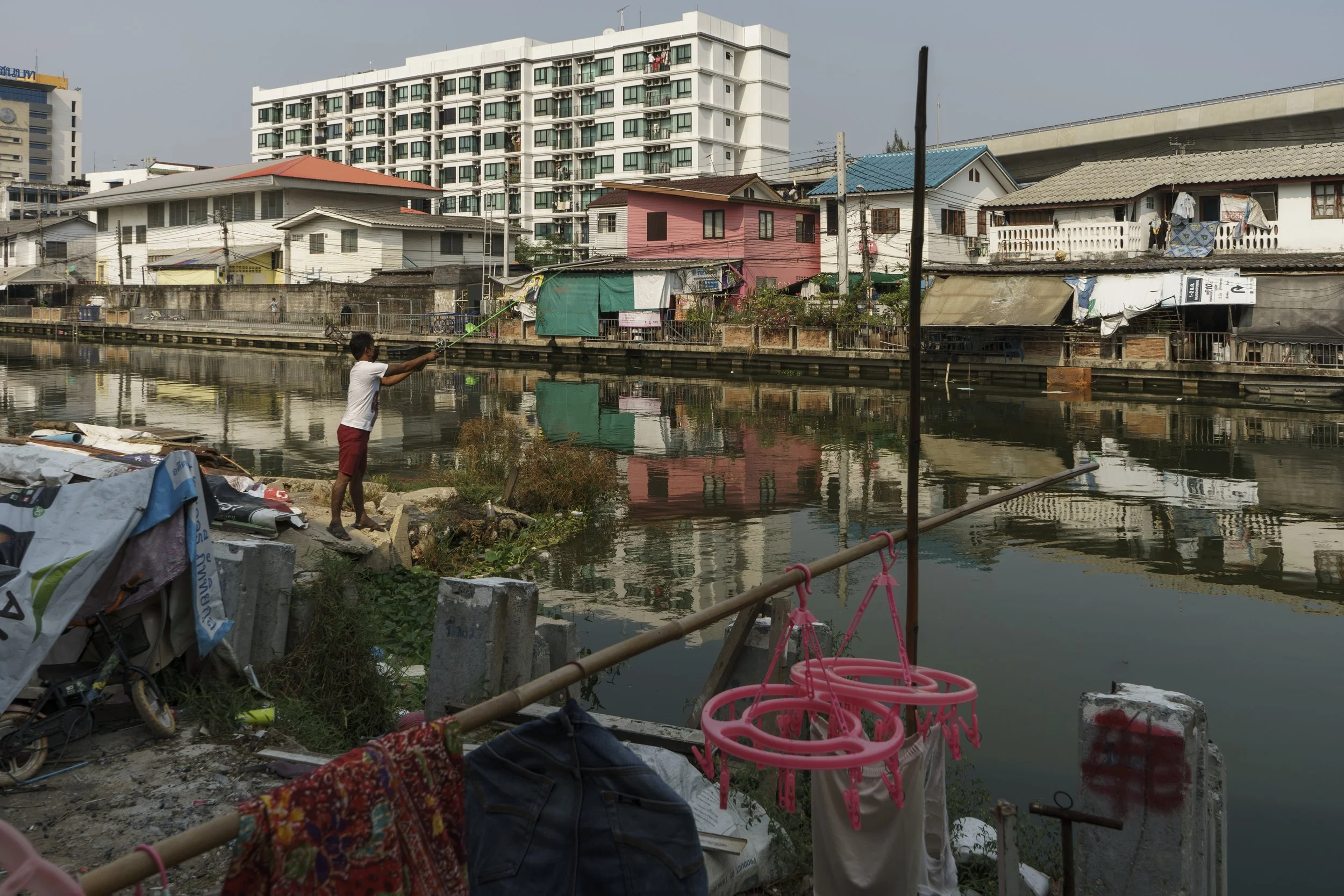 A resident fishing in the community's canal