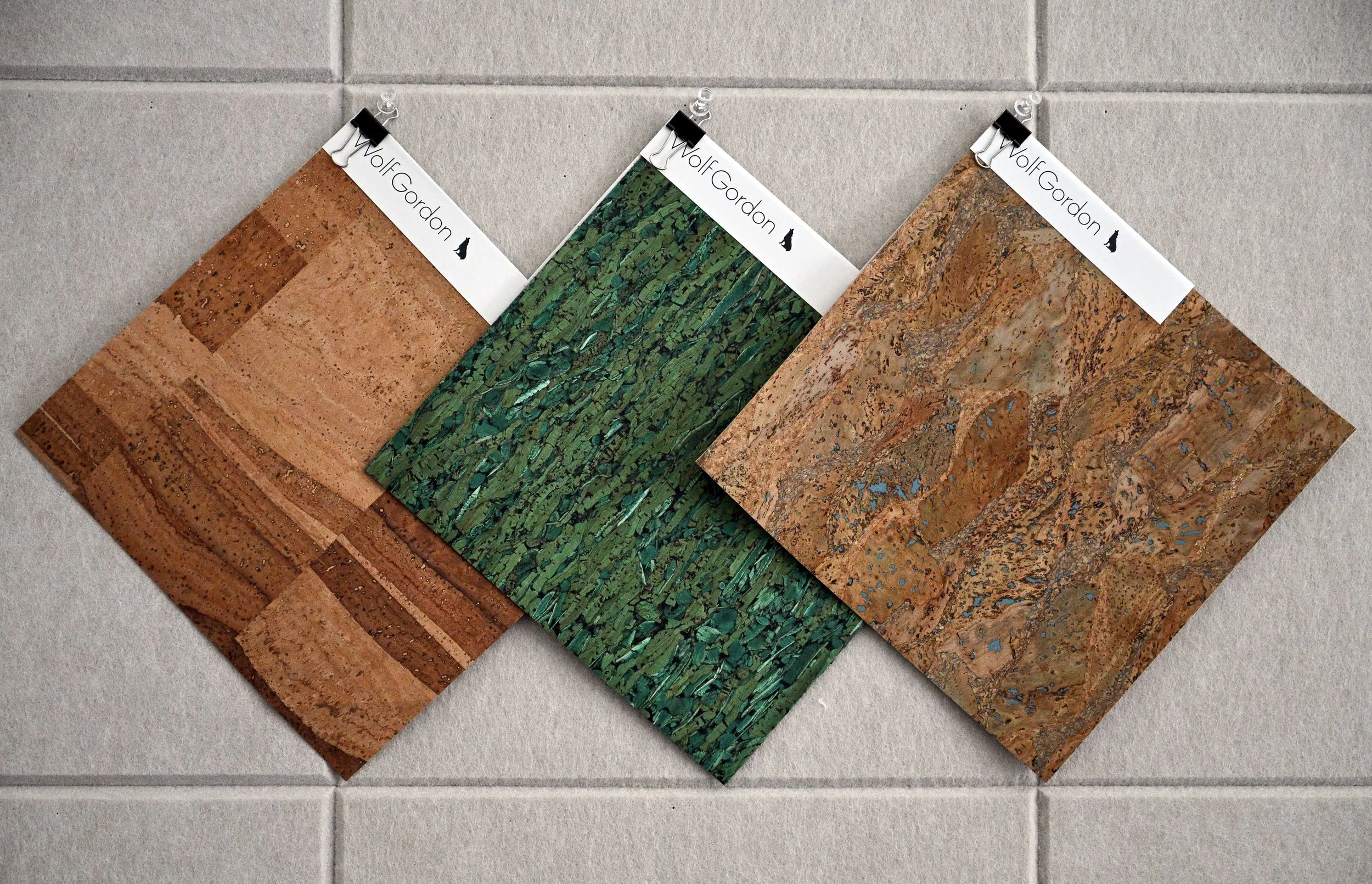 Sustainable cork wallcovering samples from Wolf-Gordon in natural and green tones, used for eco-friendly interior materials and modern residential design.