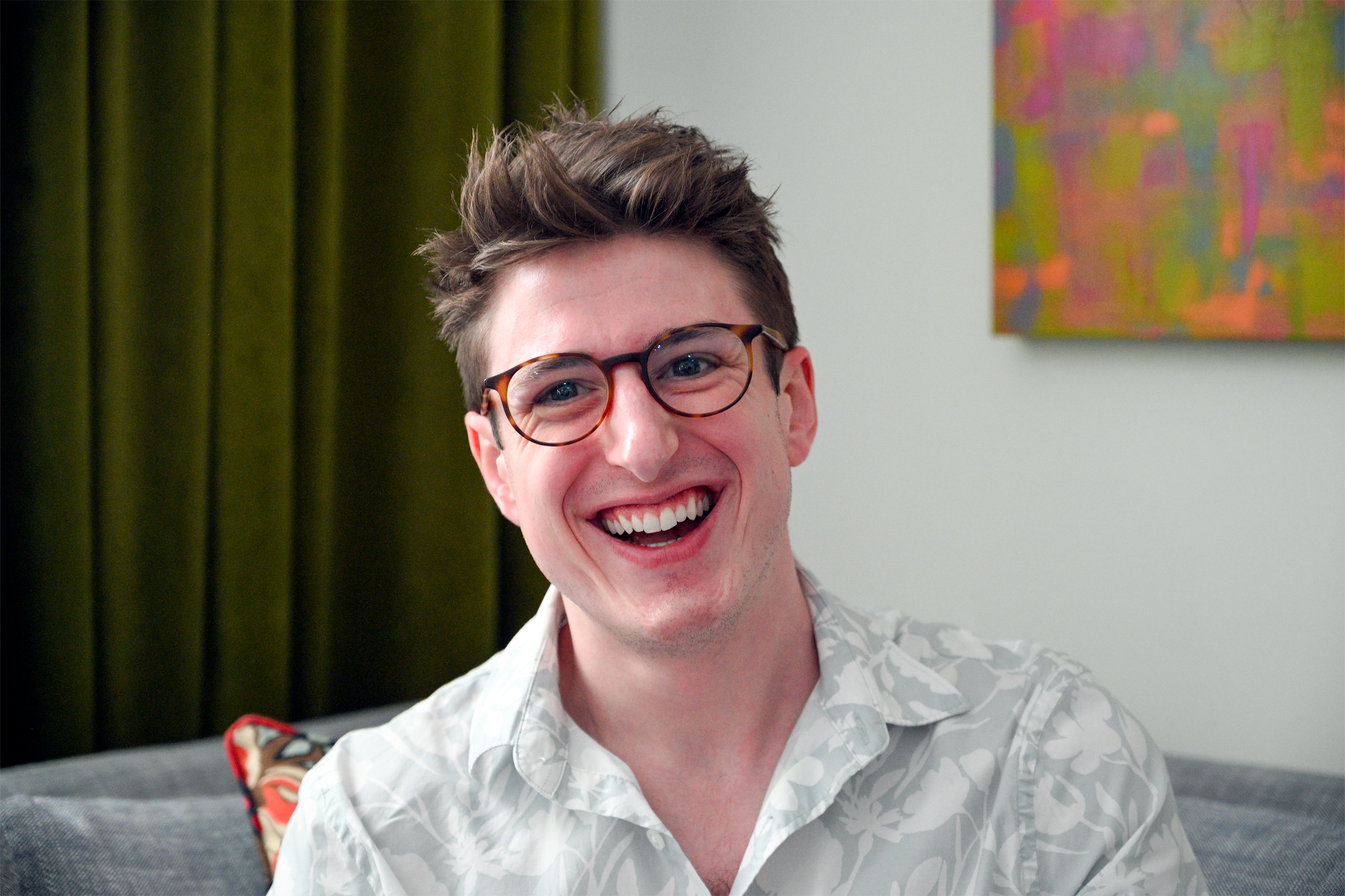 Austin Seeley, Philadelphia interior designer, smiling in luxury residential design studio.
