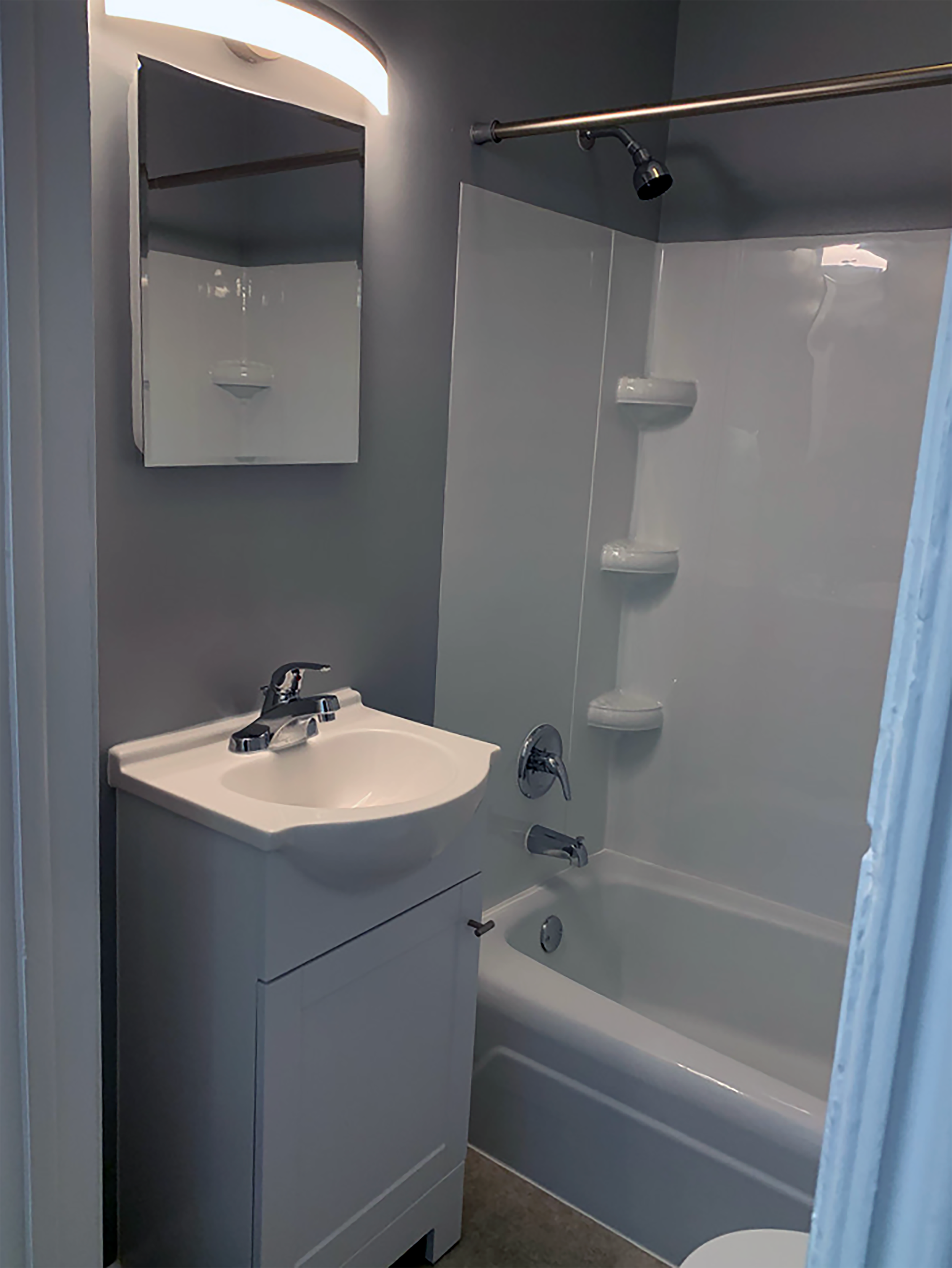 Remodeled contemporary bathroom with bathtub and vanity.