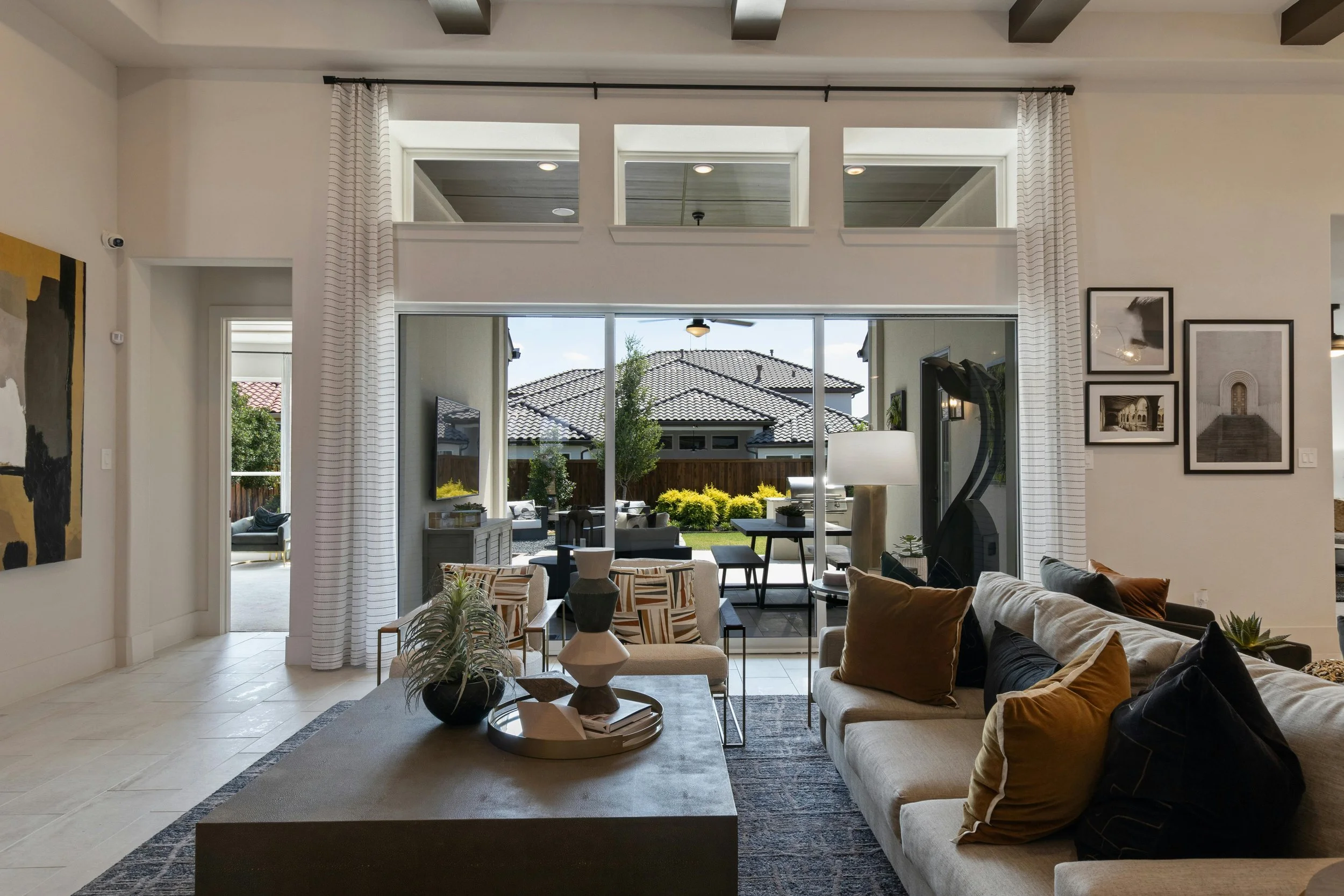 Modern living room interior with natural light, neutral furnishings, and layered textures.