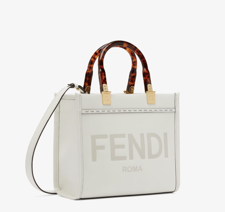A white Fendi handbag with tortoiseshell handles and gold hardware, featuring the Fendi Roma logo on the front.