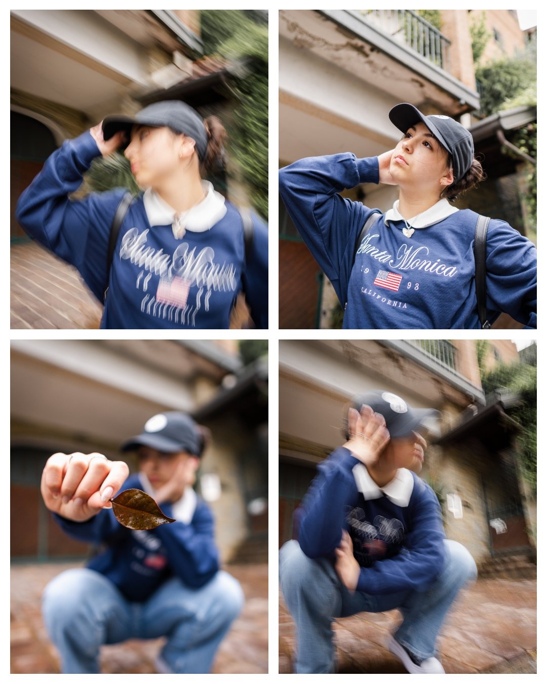 A young woman wearing a blue sweatshirt, black cap, and backpack in an outdoor urban setting. She is seen adjusting her cap, holding a leaf, and sitting on the ground in a crouched position.