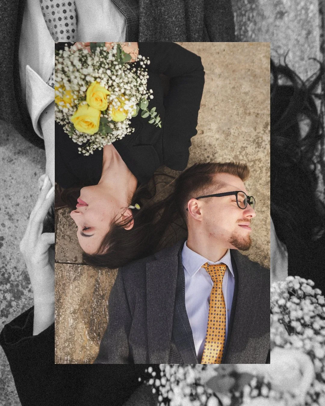 A man and woman lying on the ground, both with eyes closed. The woman is holding a bouquet of yellow roses and white baby's breath flowers.