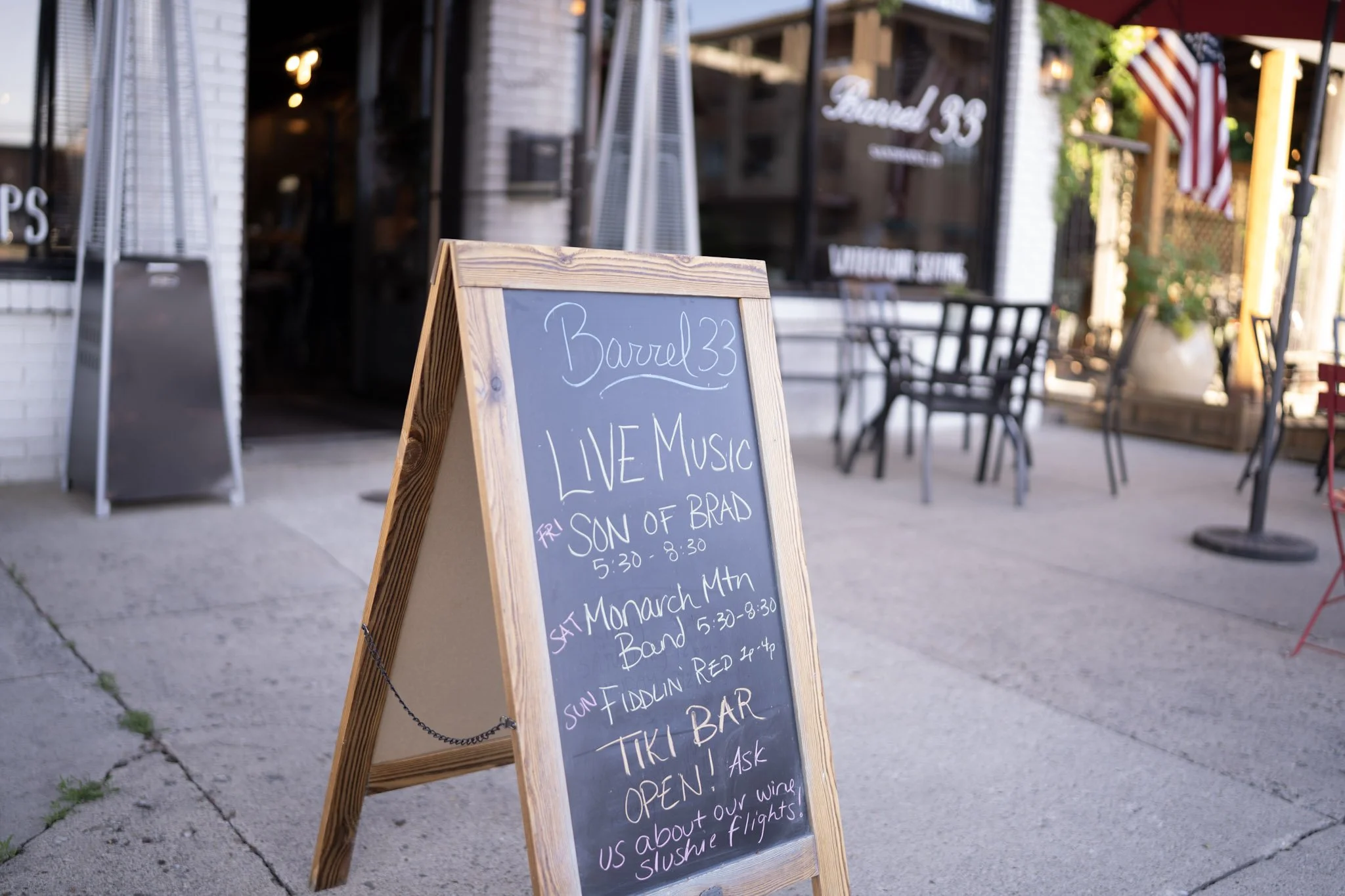 A chalk board with a list of live events outside of Barrel 33