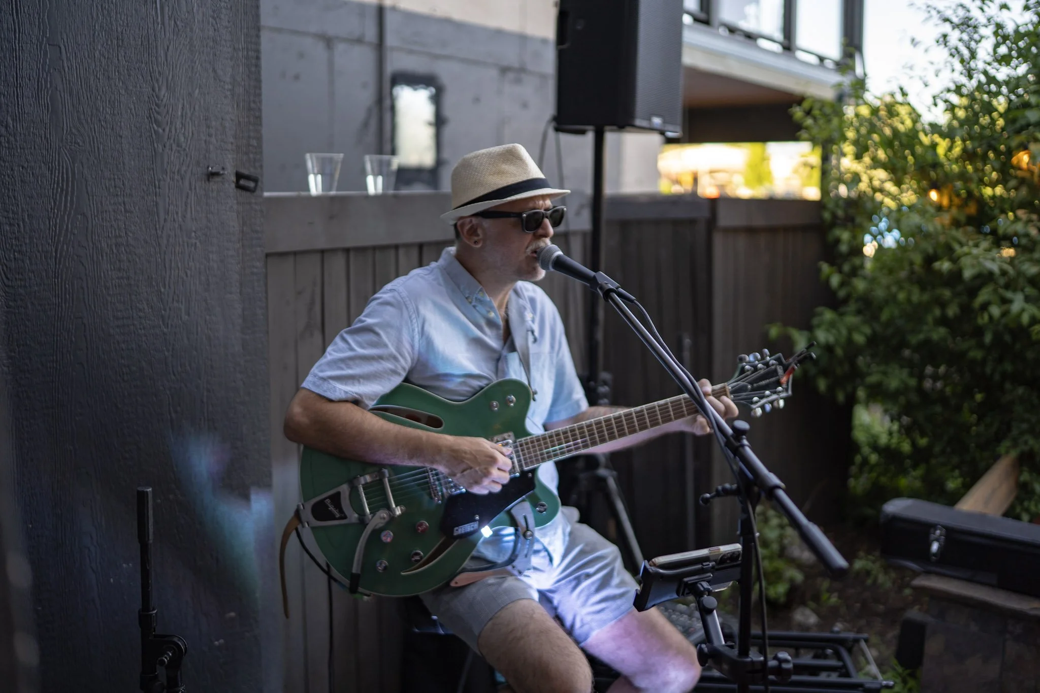 Man playing guitar on outside patio